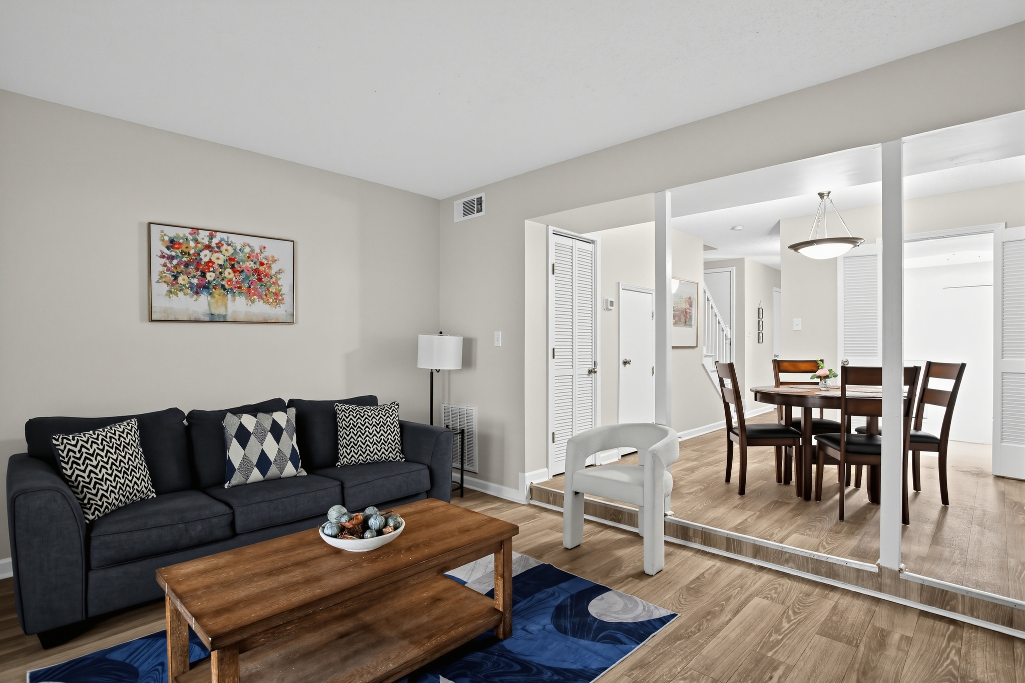 Bright open living and dining area with stylish decor and seating for 4