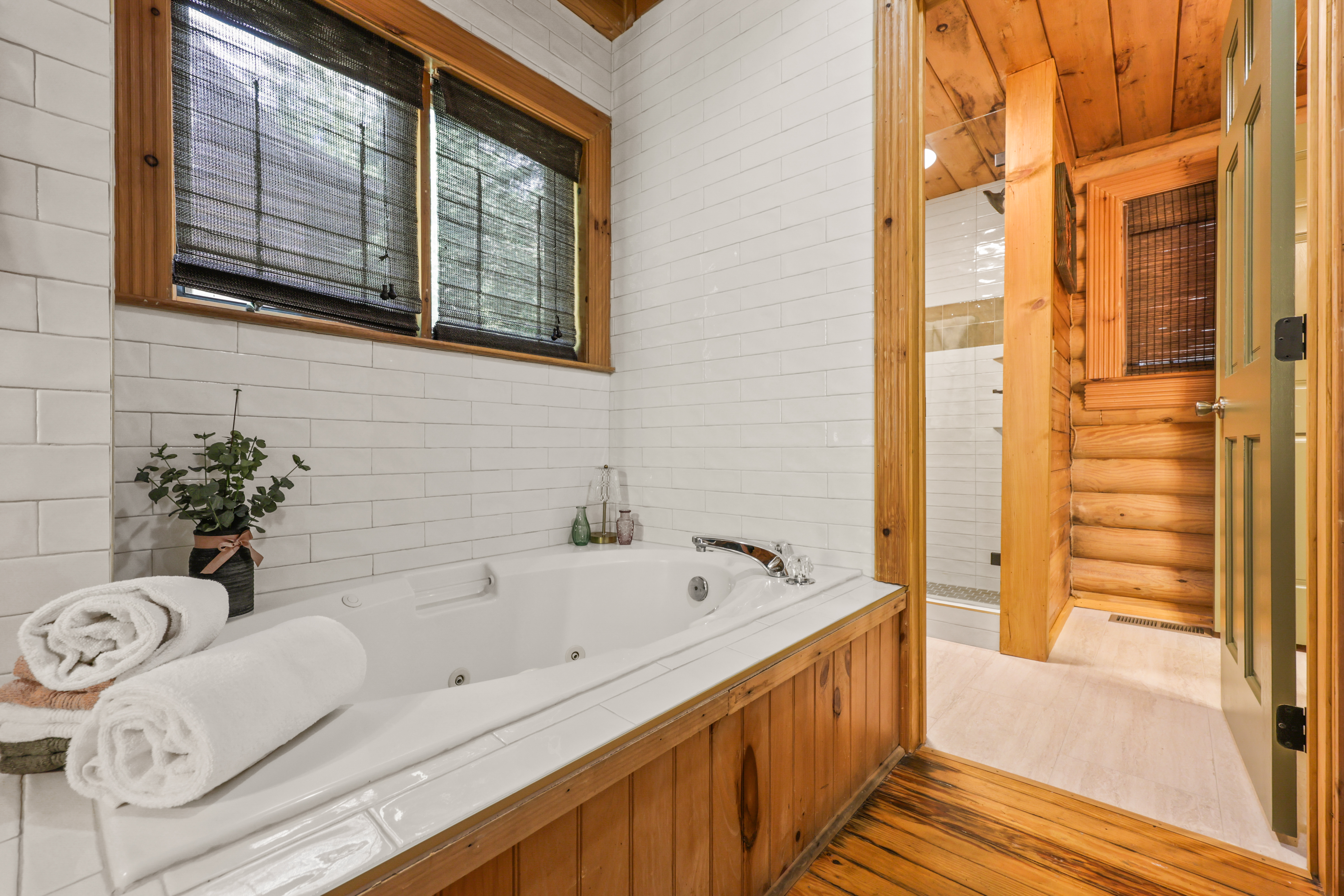 Rustic spa-style bath with jetted tub and warm cabin charm