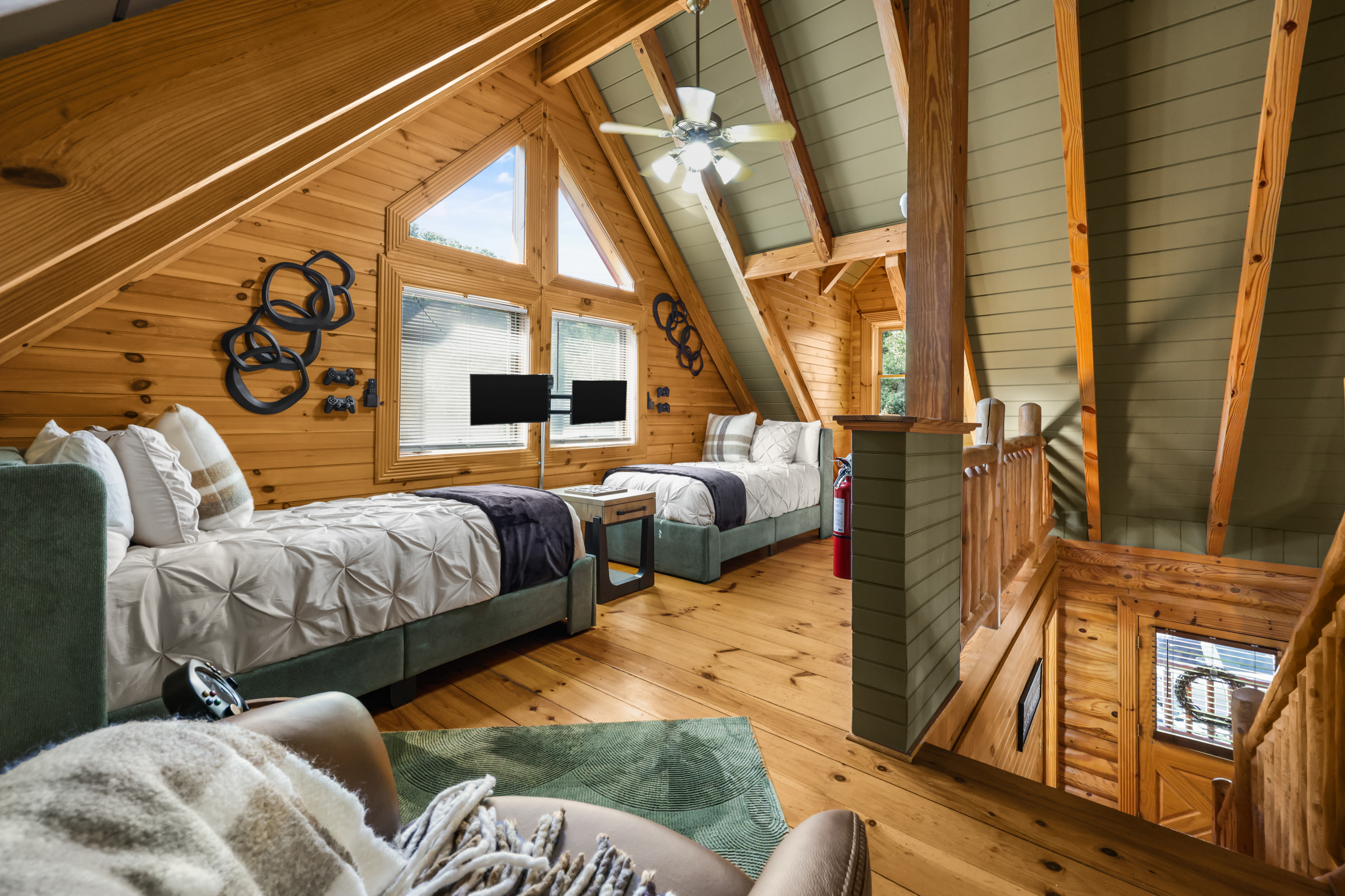 Charming loft with twin beds, vaulted ceilings, and warm cabin style