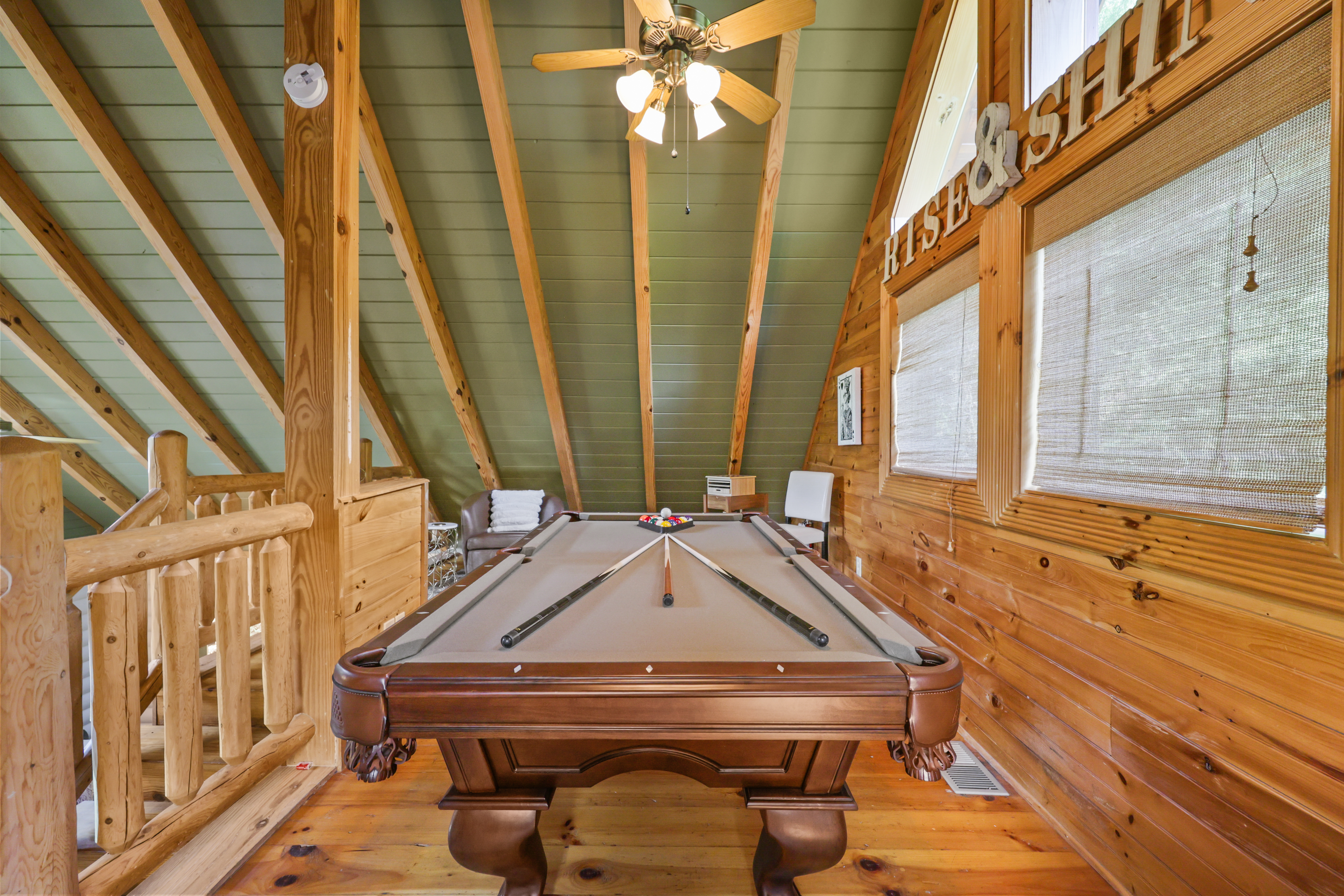 Cozy loft game room with pool table and rustic cabin charm