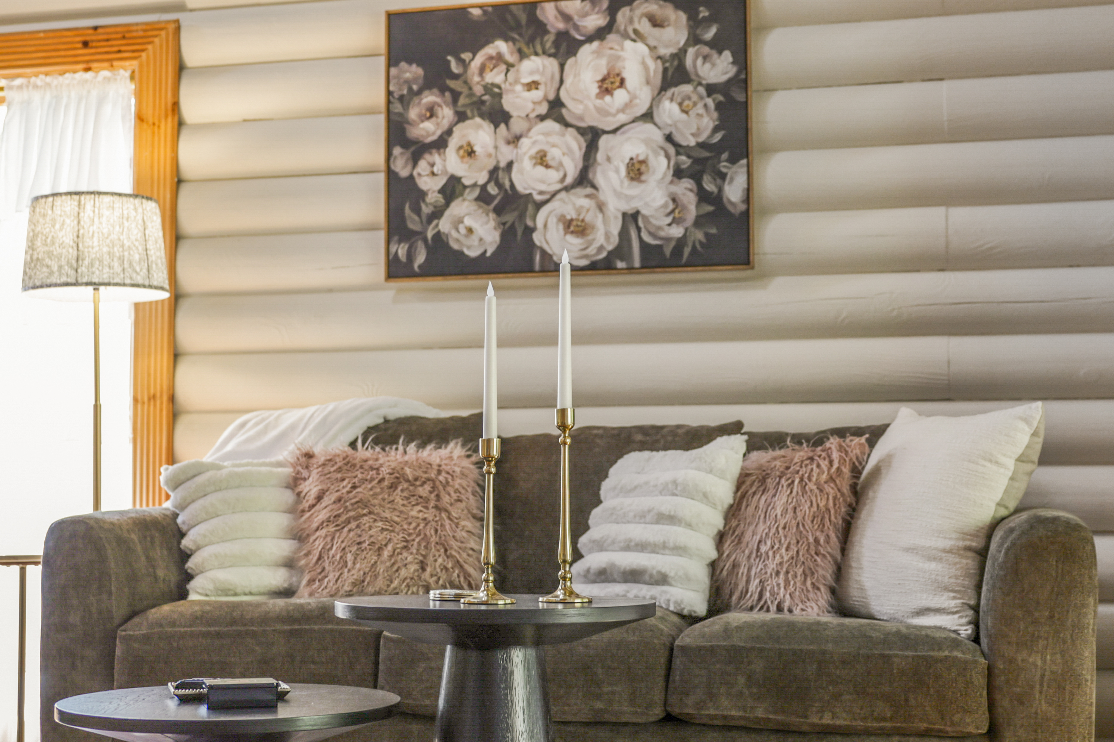 Cozy cabin-style lounge with plush seating and warm rustic charm