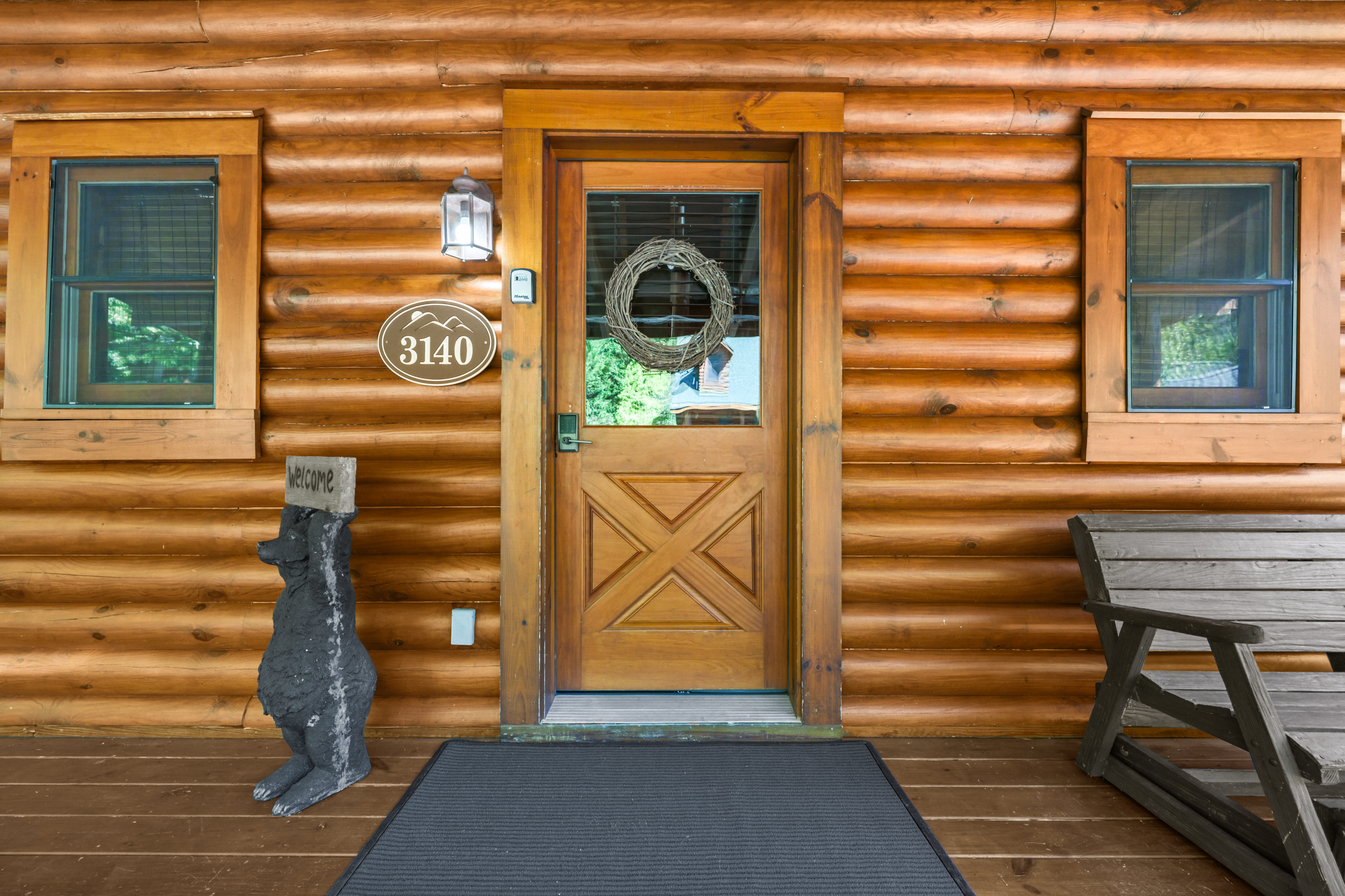 Welcoming log cabin entry with cozy porch charm and rustic lodge style