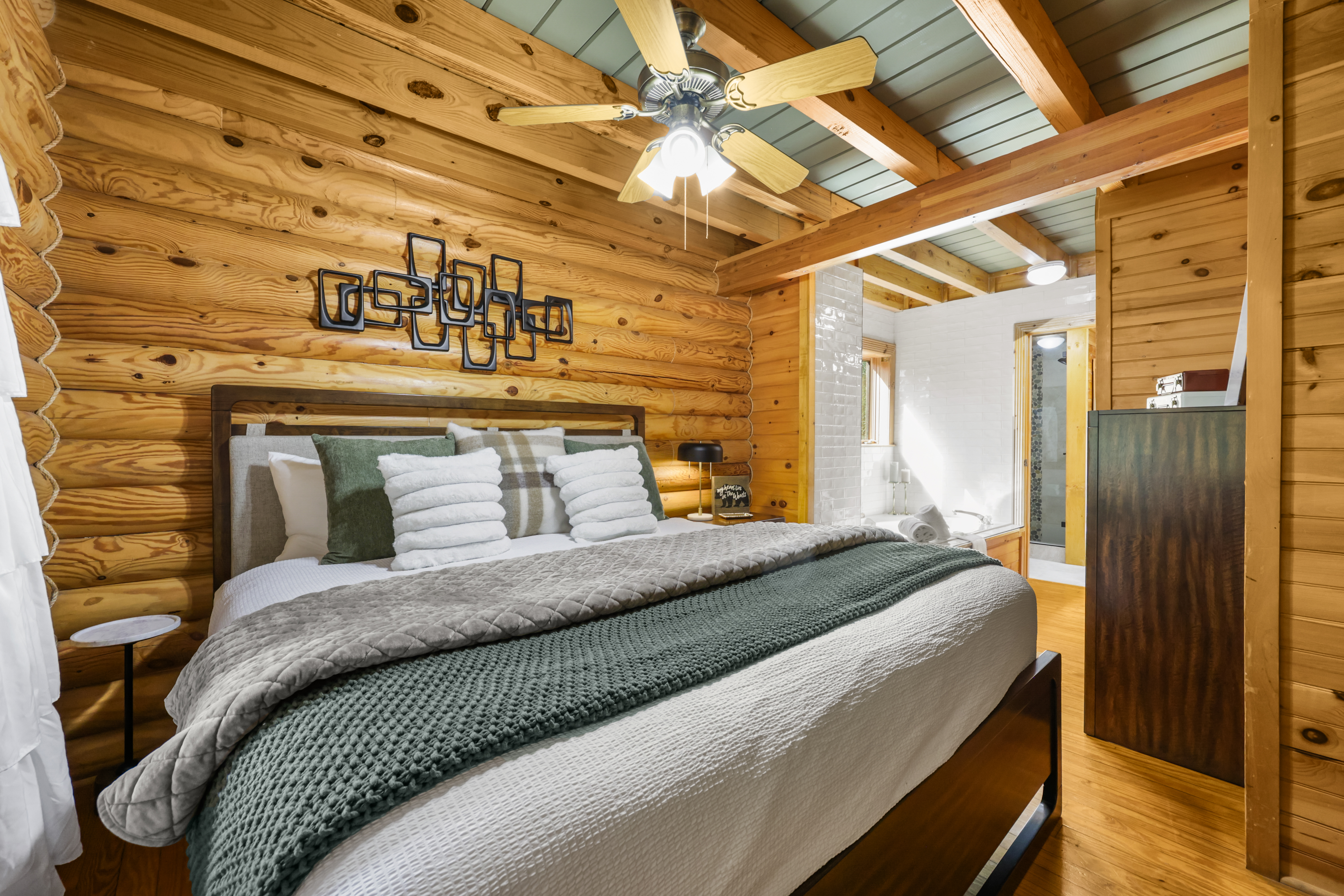 Rustic log cabin suite with a plush king bed and warm wood interiors