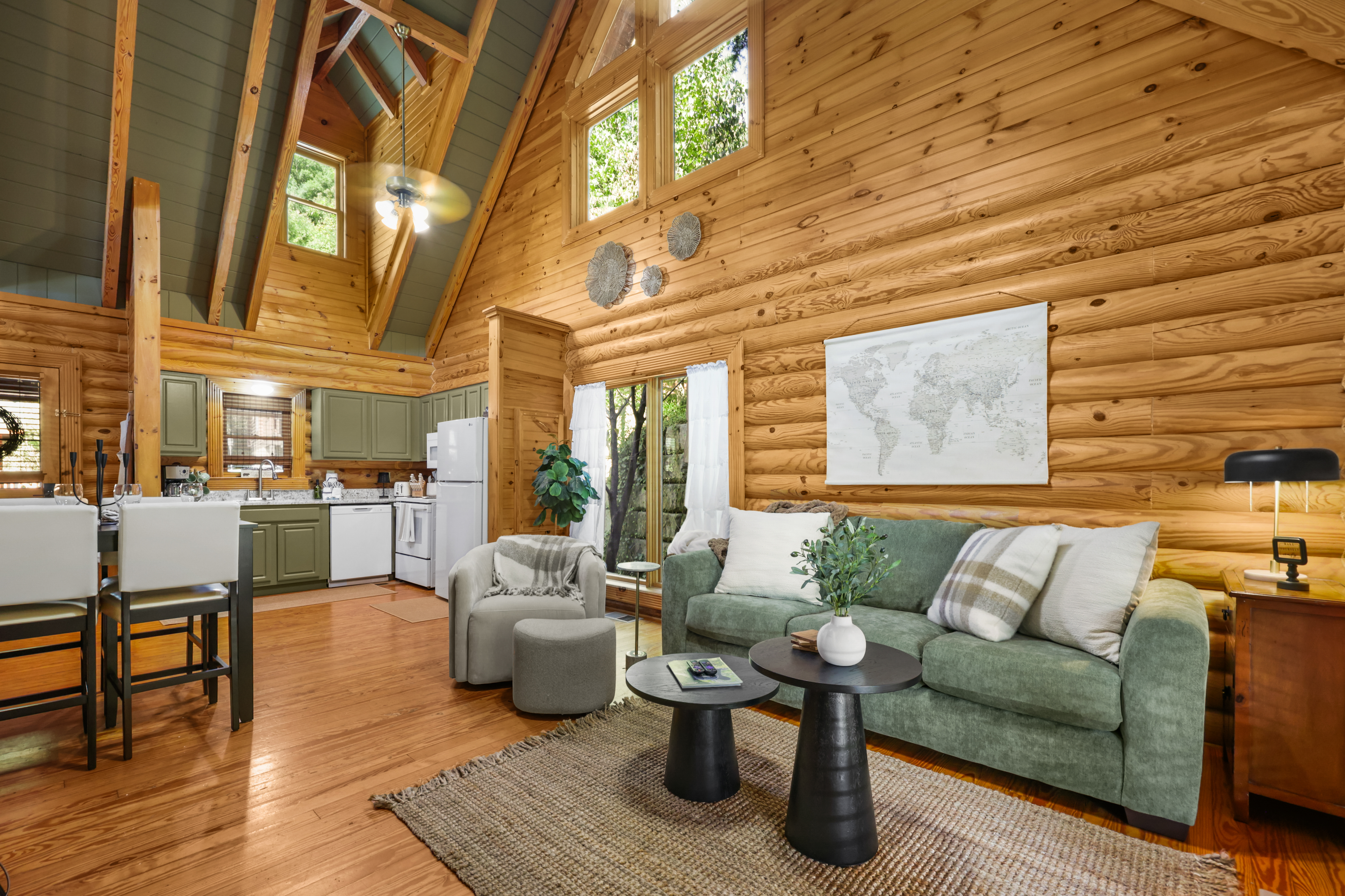 Cozy log cabin great room with vaulted ceilings and bright open living