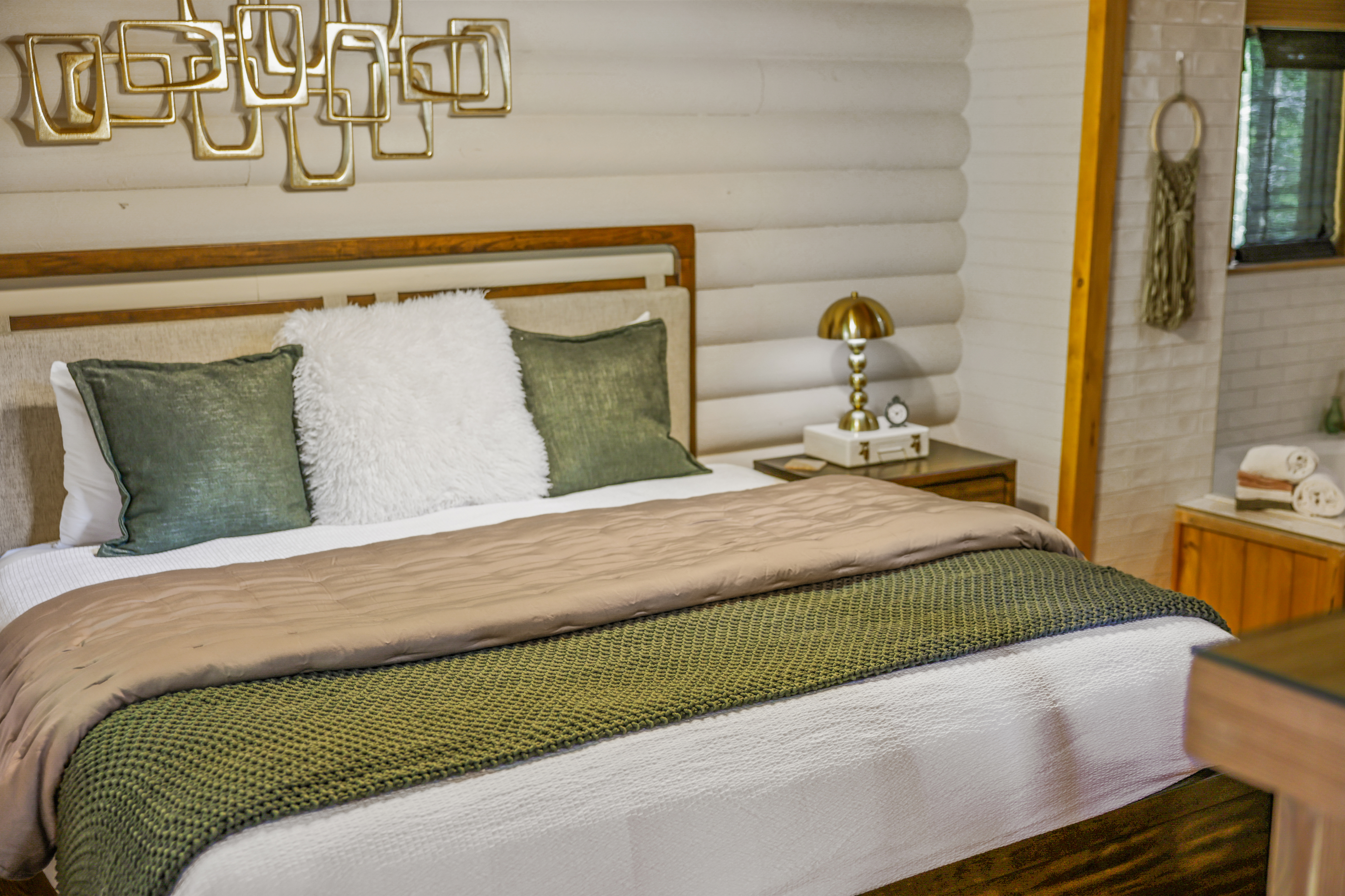 Cozy rustic-modern bedroom with plush bedding and warm designer touches