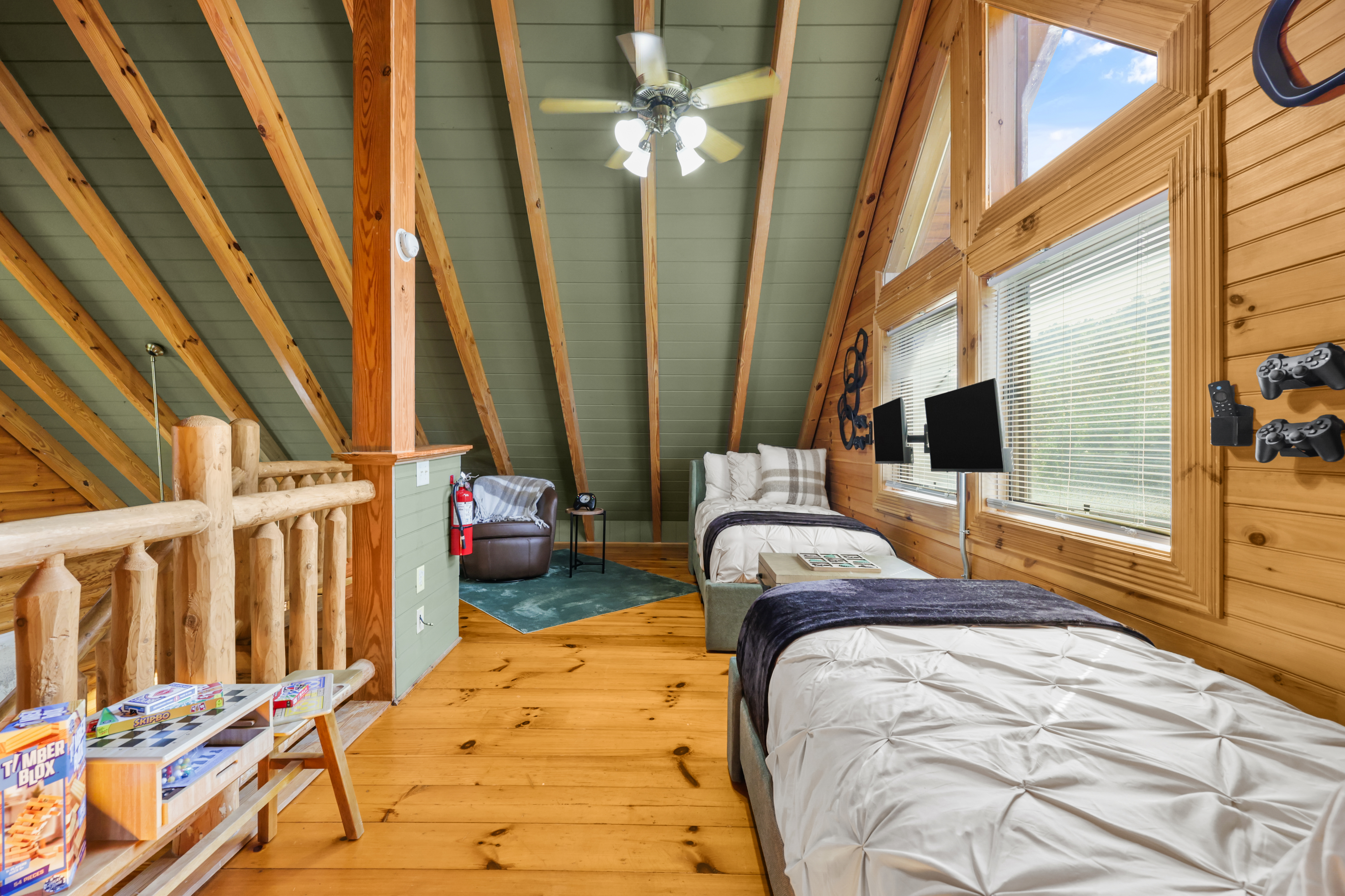 Cozy loft with twin beds, TVs, and rustic cabin charm