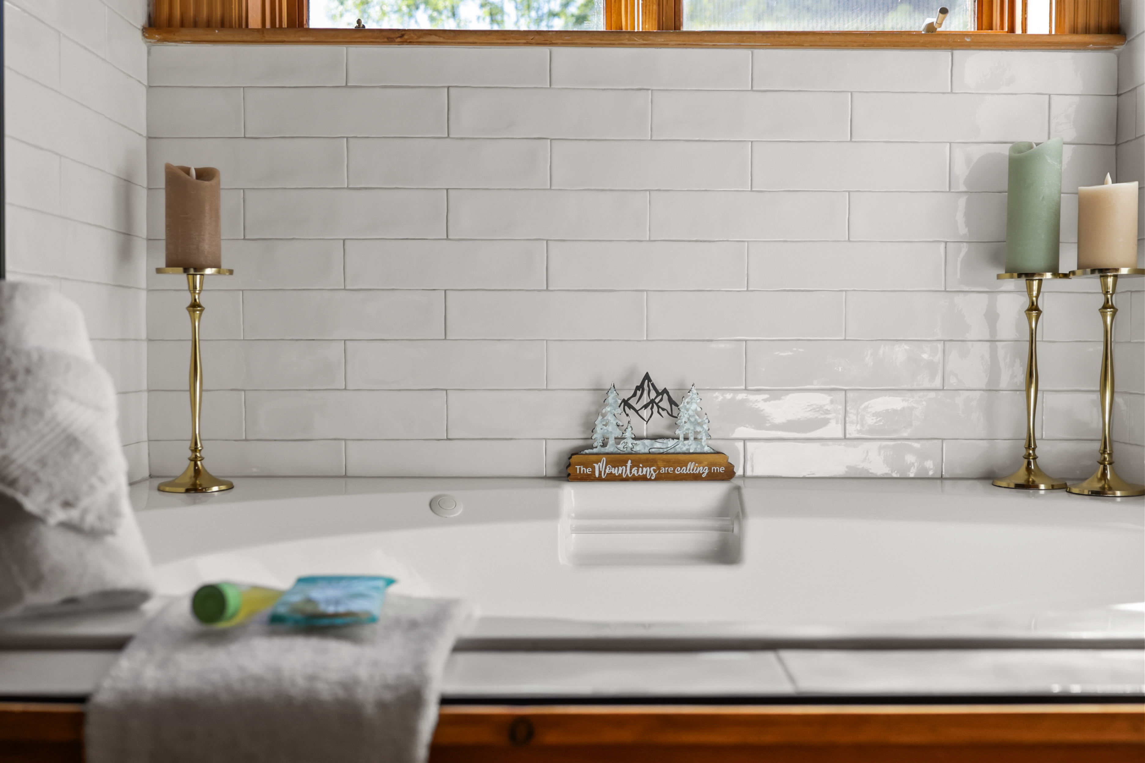 Spa-like soaking tub with clean tile and warm, relaxing touches