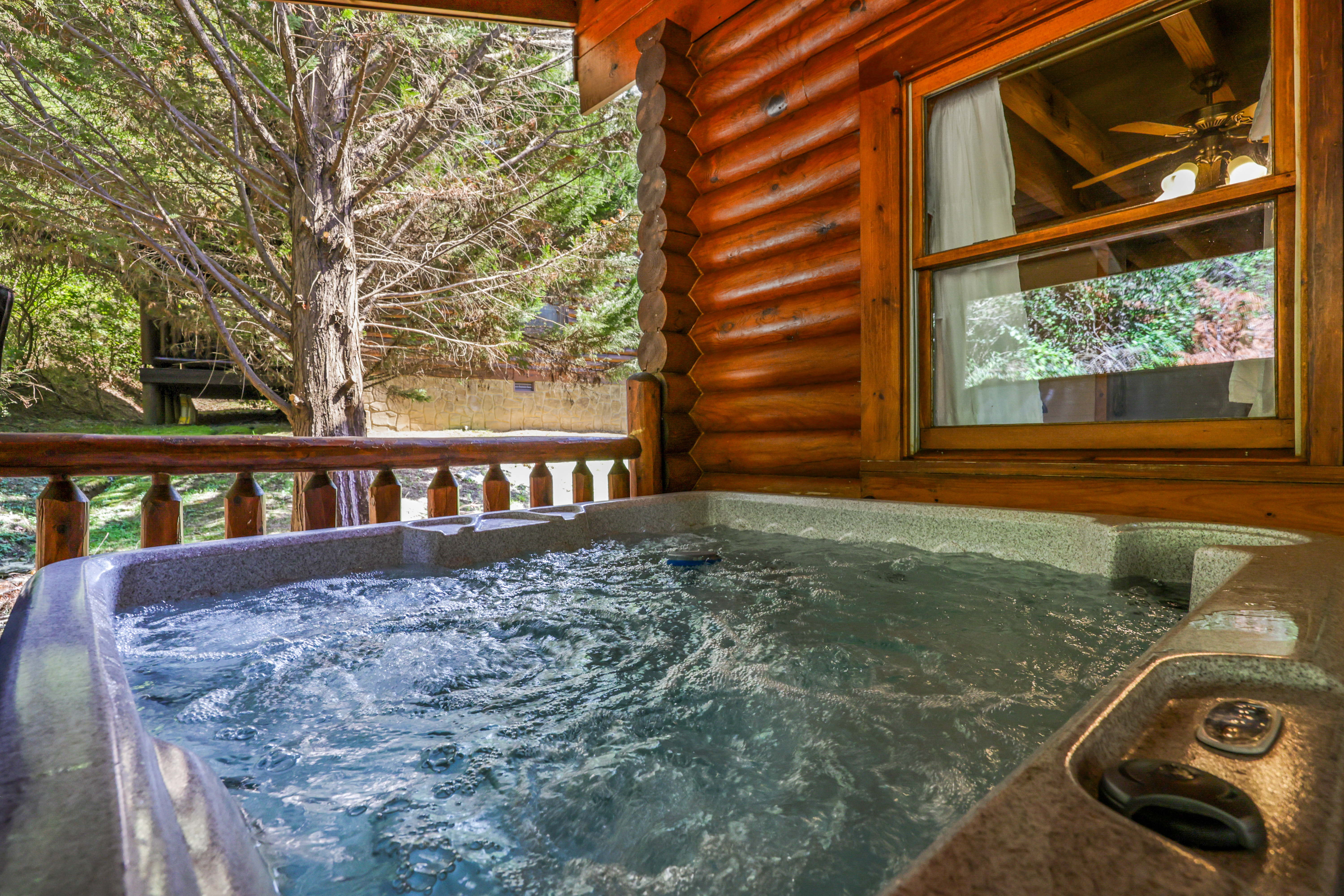 Private porch hot tub with peaceful wooded views and cozy cabin charm
