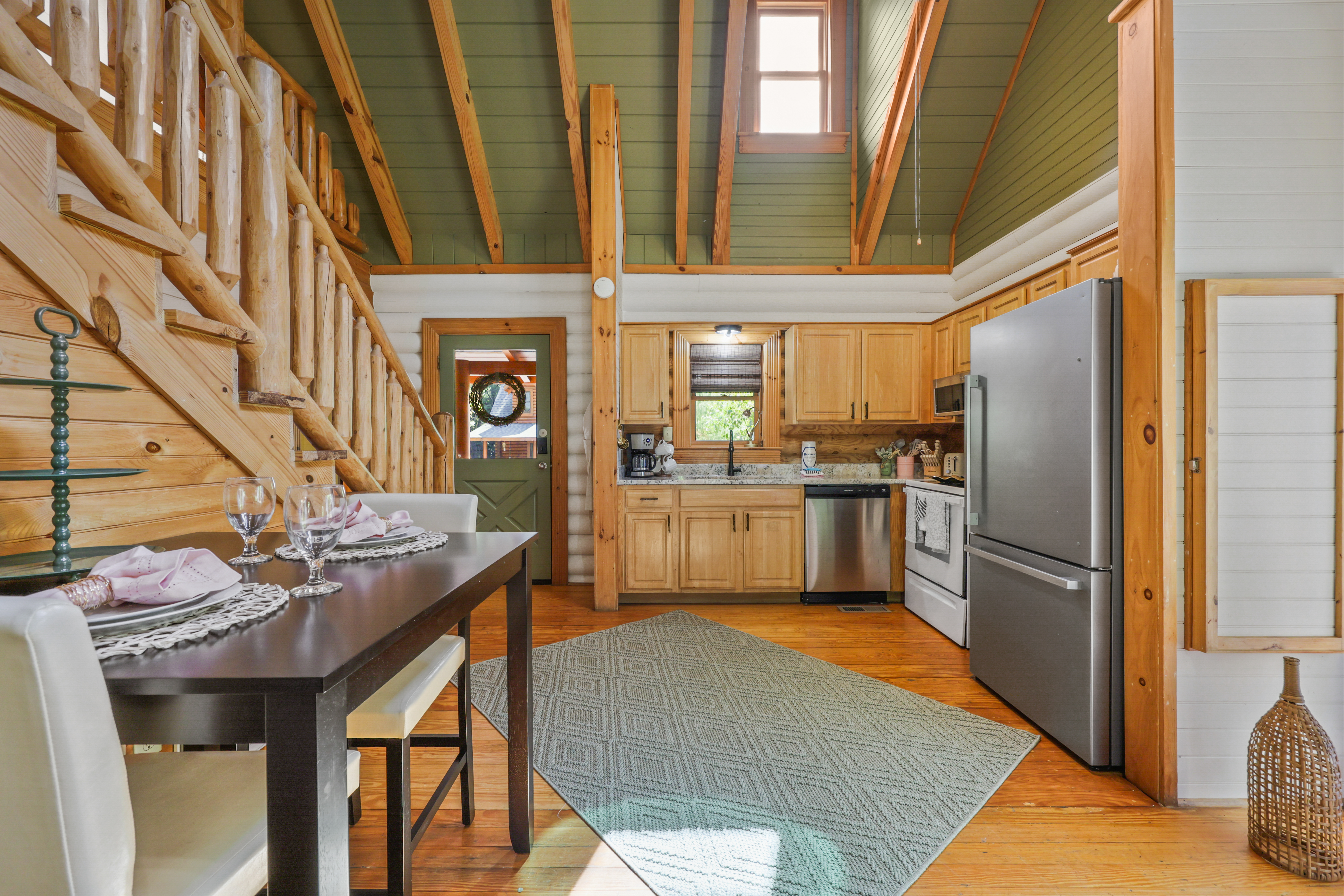 Rustic cabin kitchen with vaulted ceilings and cozy dining space