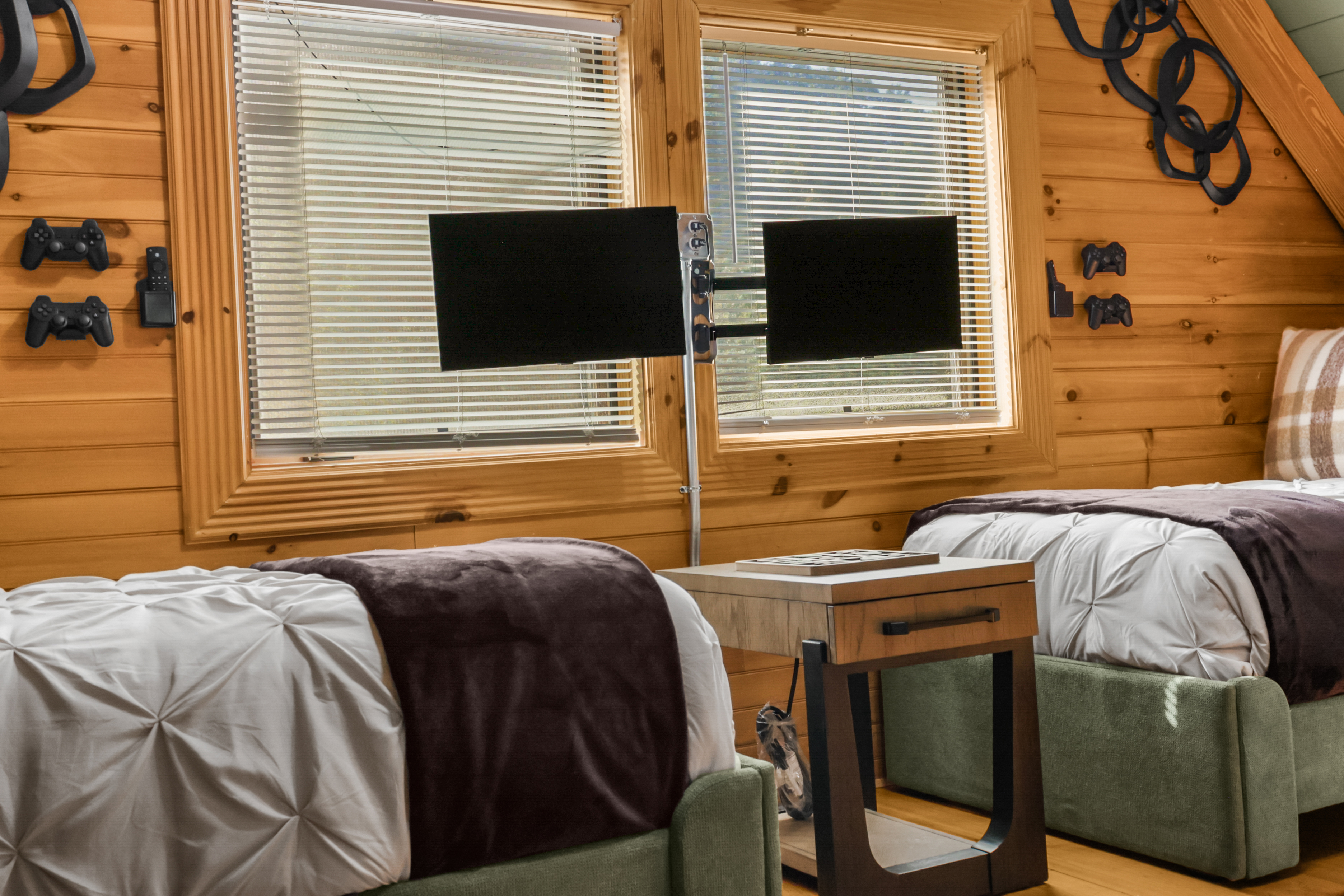Cozy twin bedroom with dual screens and fun game-themed decor