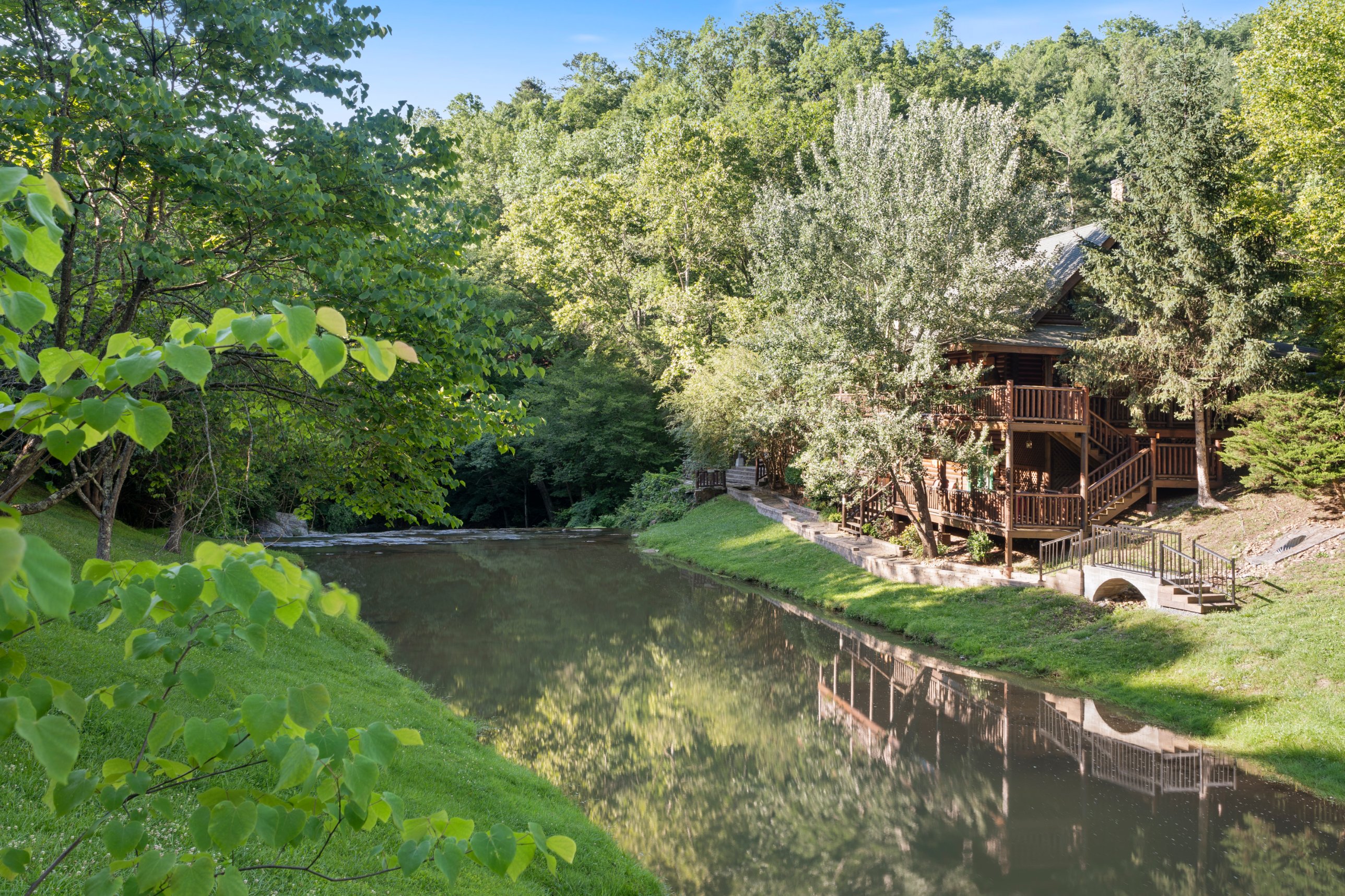 The creek that winds through Smoky Mountain Ridge. Shared community space; the cabin pictured belongs to a neighbor.