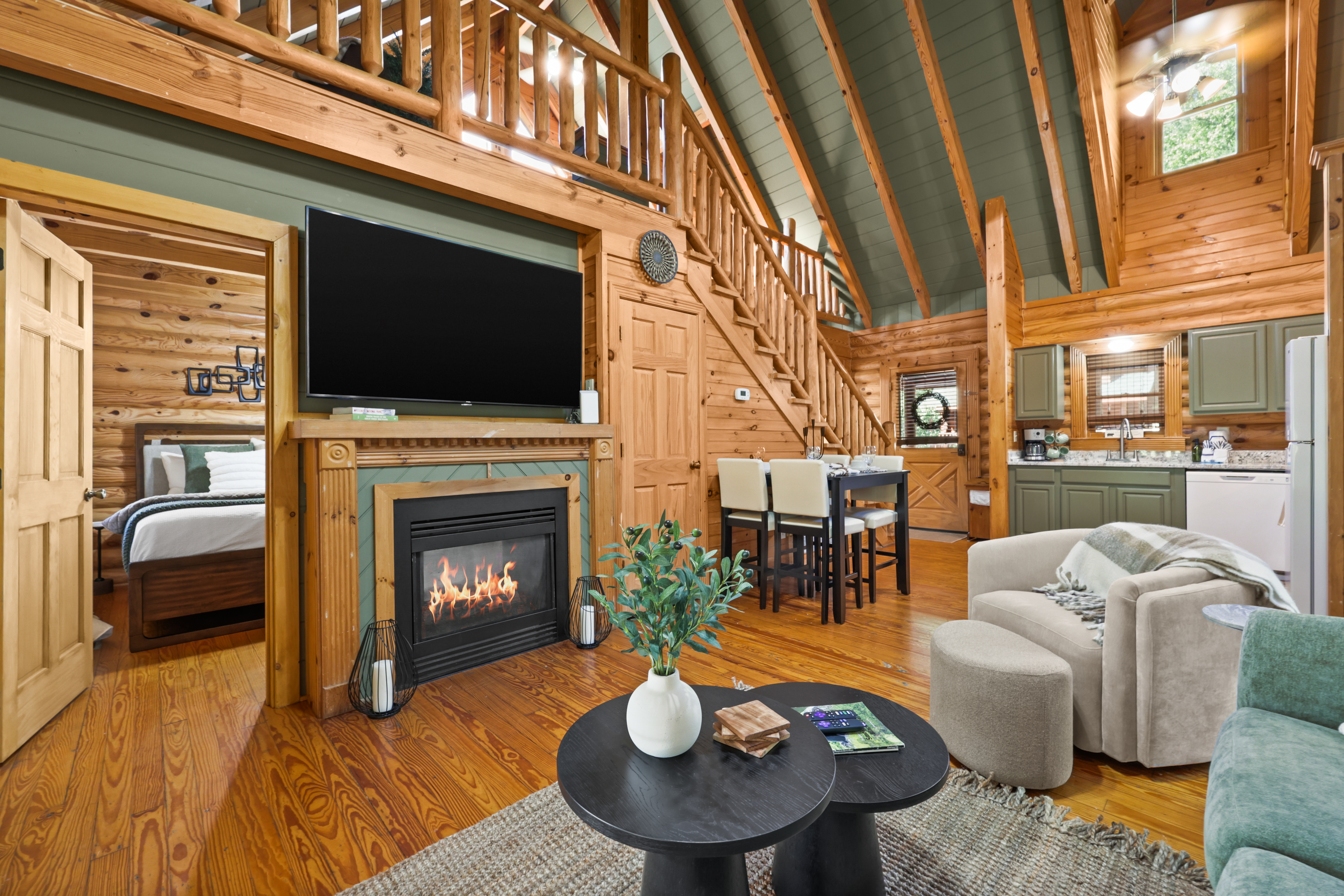 Cozy log cabin great room with fireplace, loft, and open-concept charm