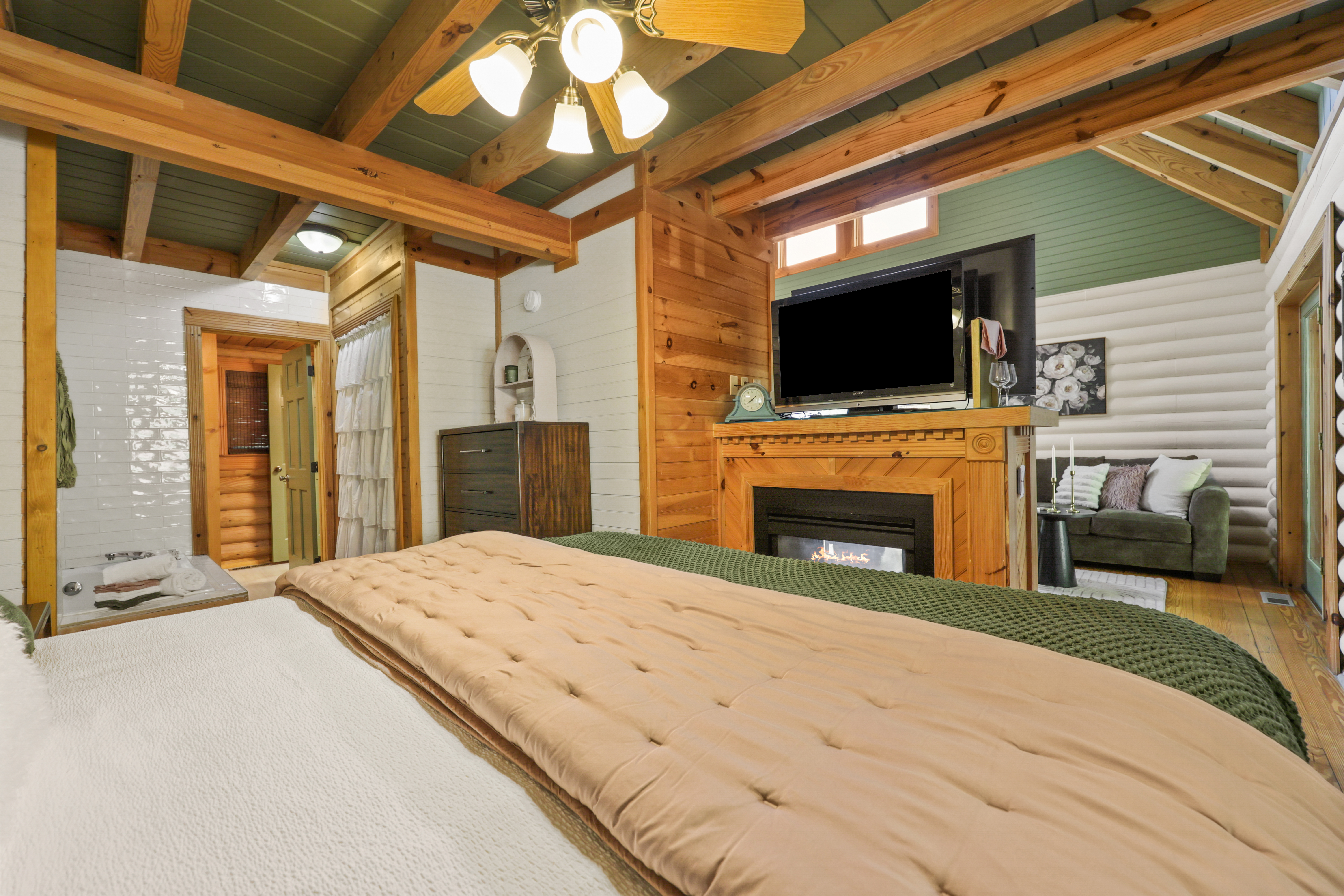 Cozy cabin suite with fireplace, TV, en-suite bath, and rustic charm