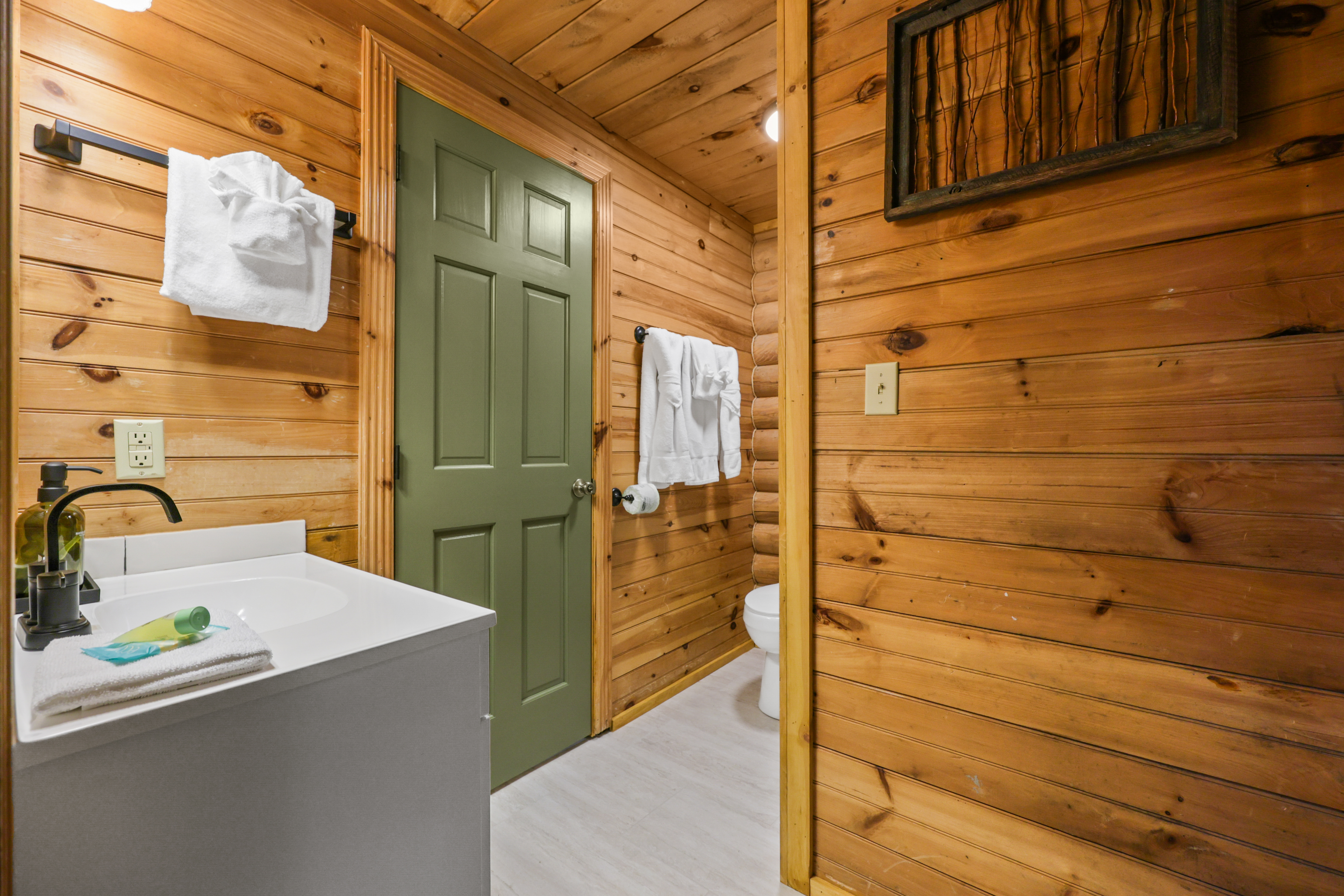 Cozy cabin-style bathroom with warm wood finishes and modern touches