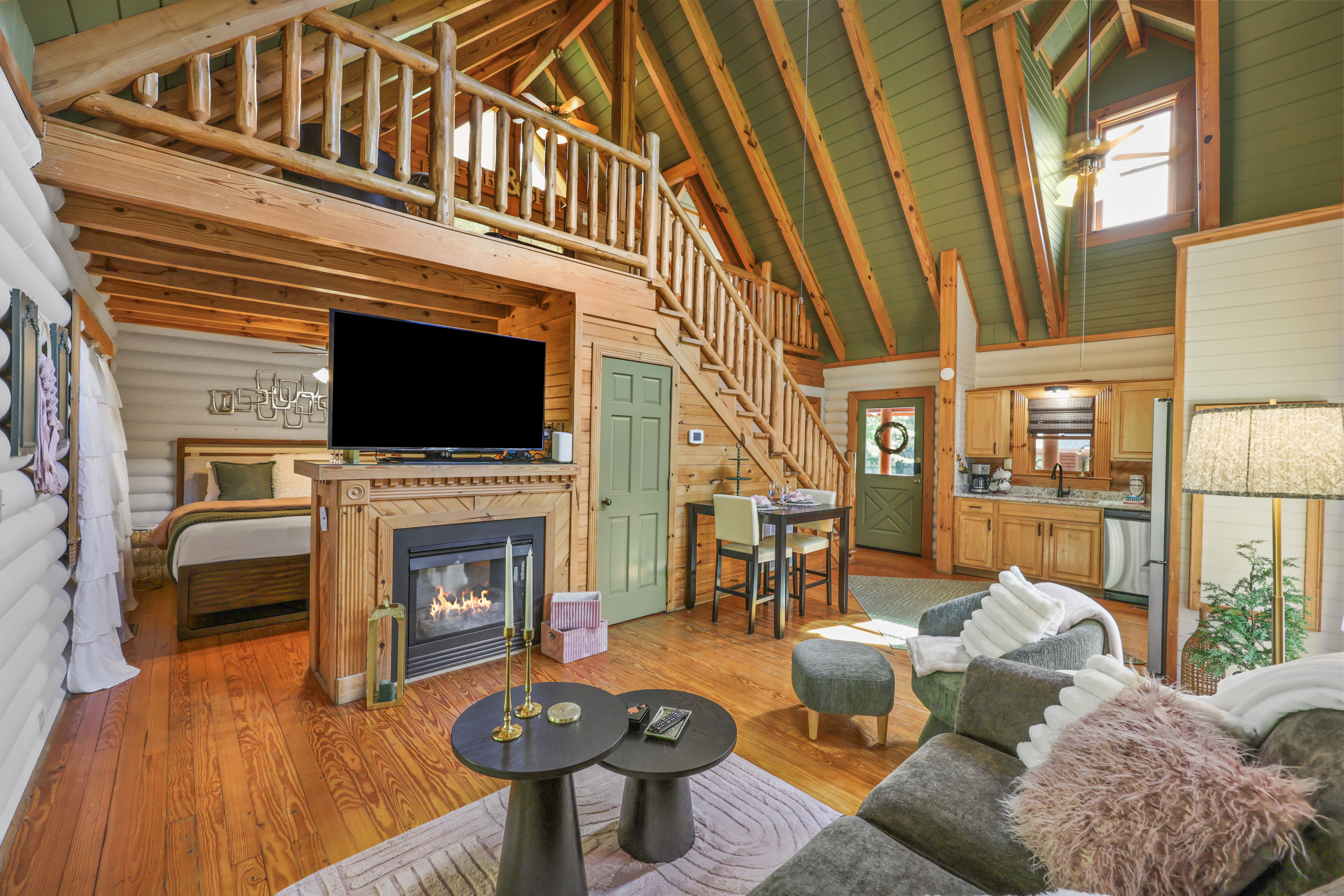 Cozy lofted cabin with fireplace, vaulted ceilings, and rustic charm