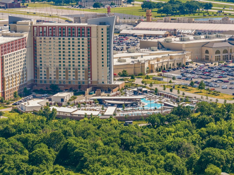 Resort-style stay with a large pool complex and scenic green surroundings