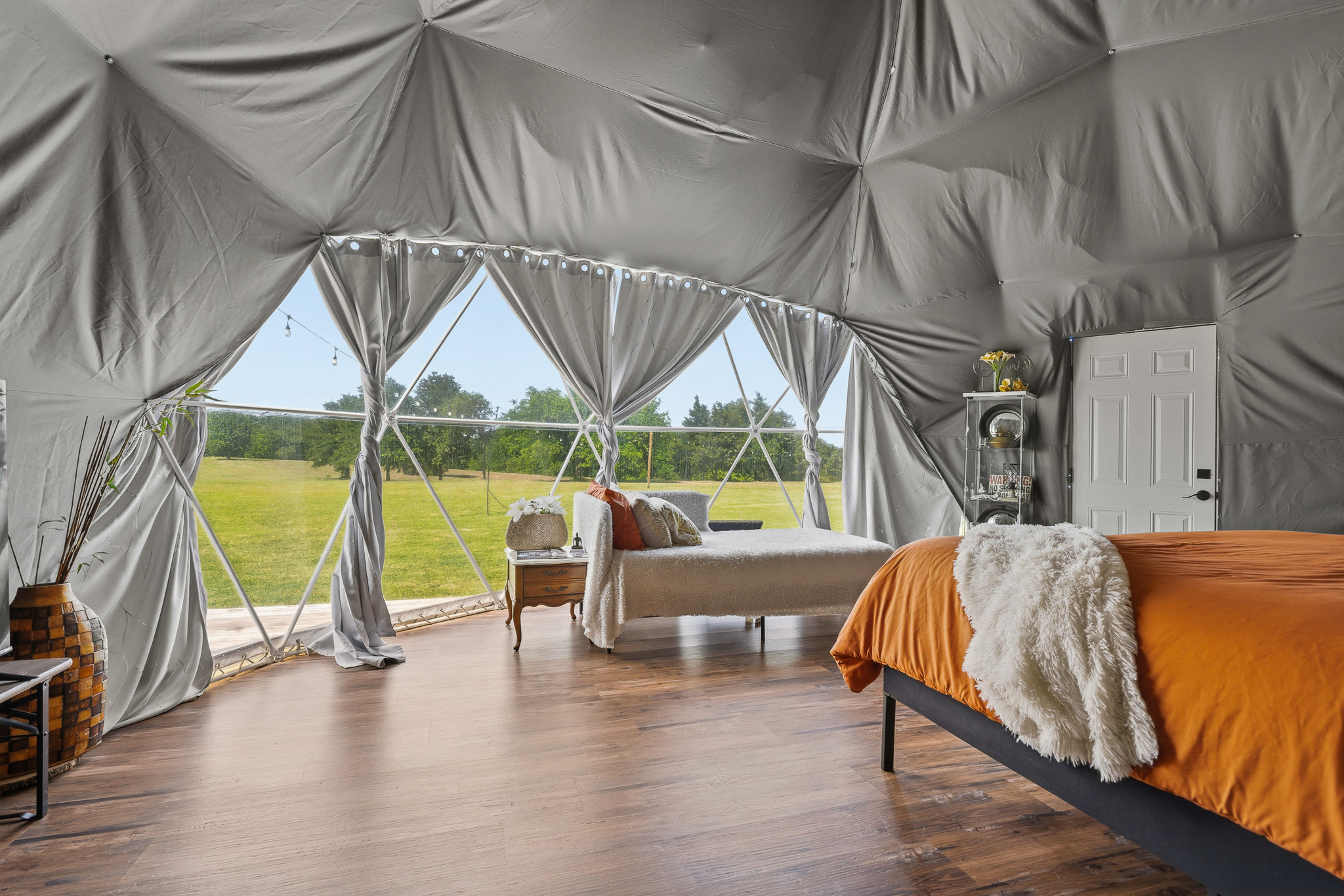 Spacious dome retreat with two beds, wood floors, and scenic views