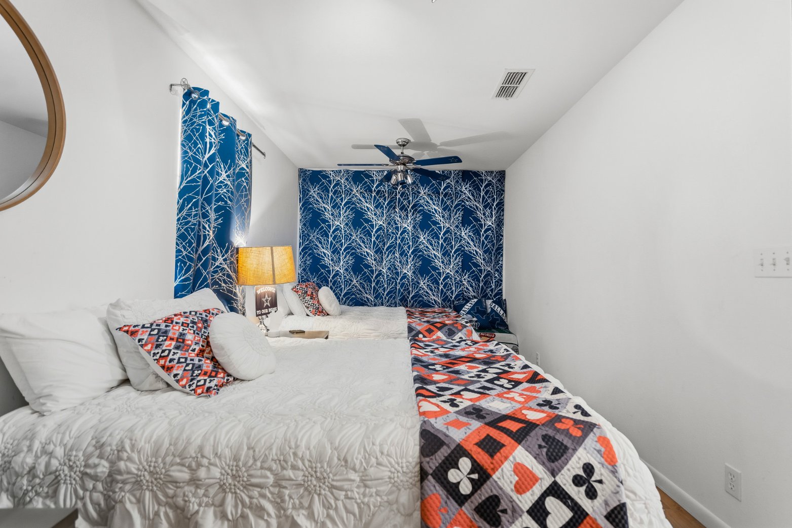 Cozy double-bed room with bold blue accents and a stylish, inviting feel