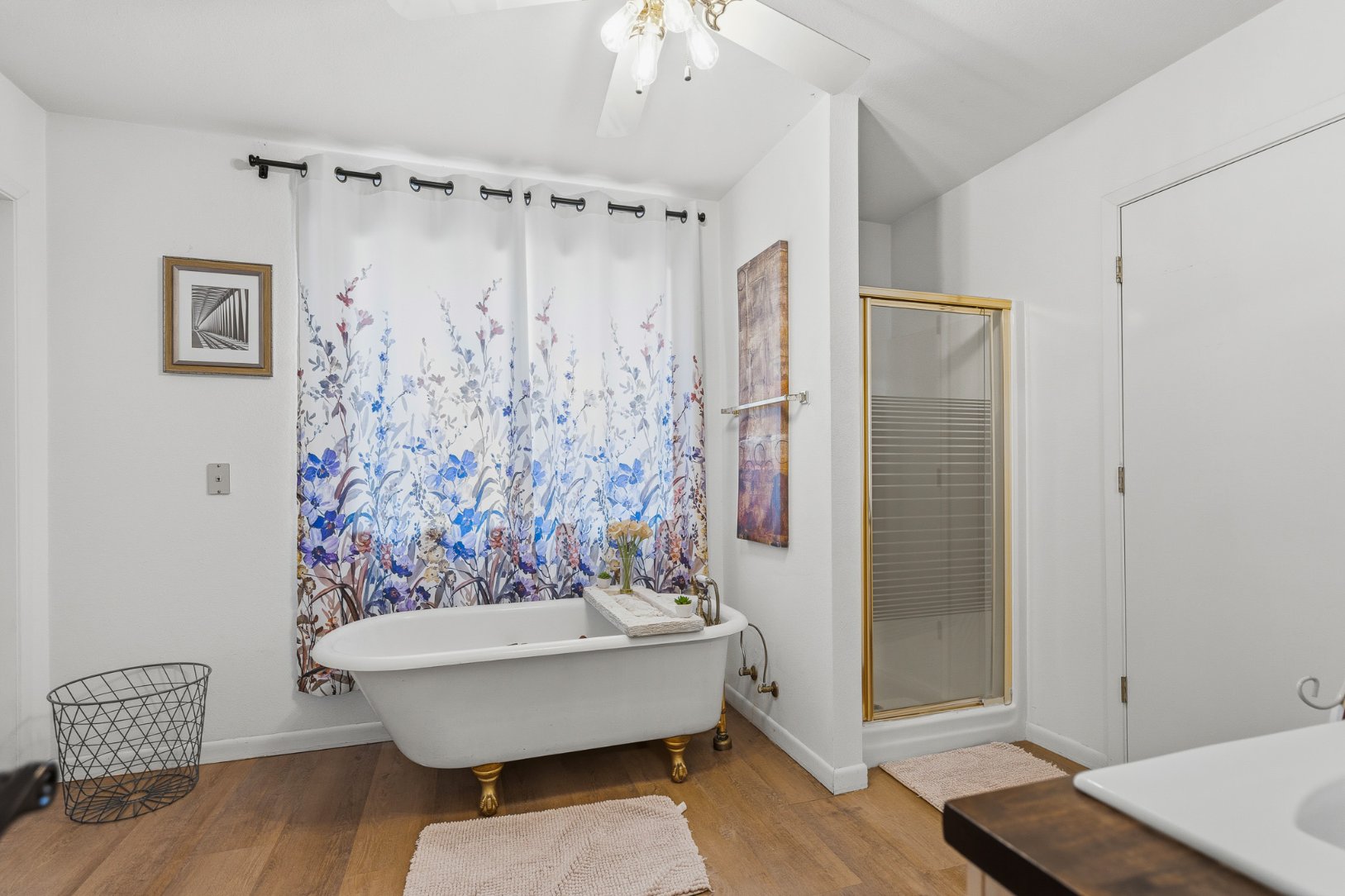 Spa-like bathroom with clawfoot tub and separate glass shower