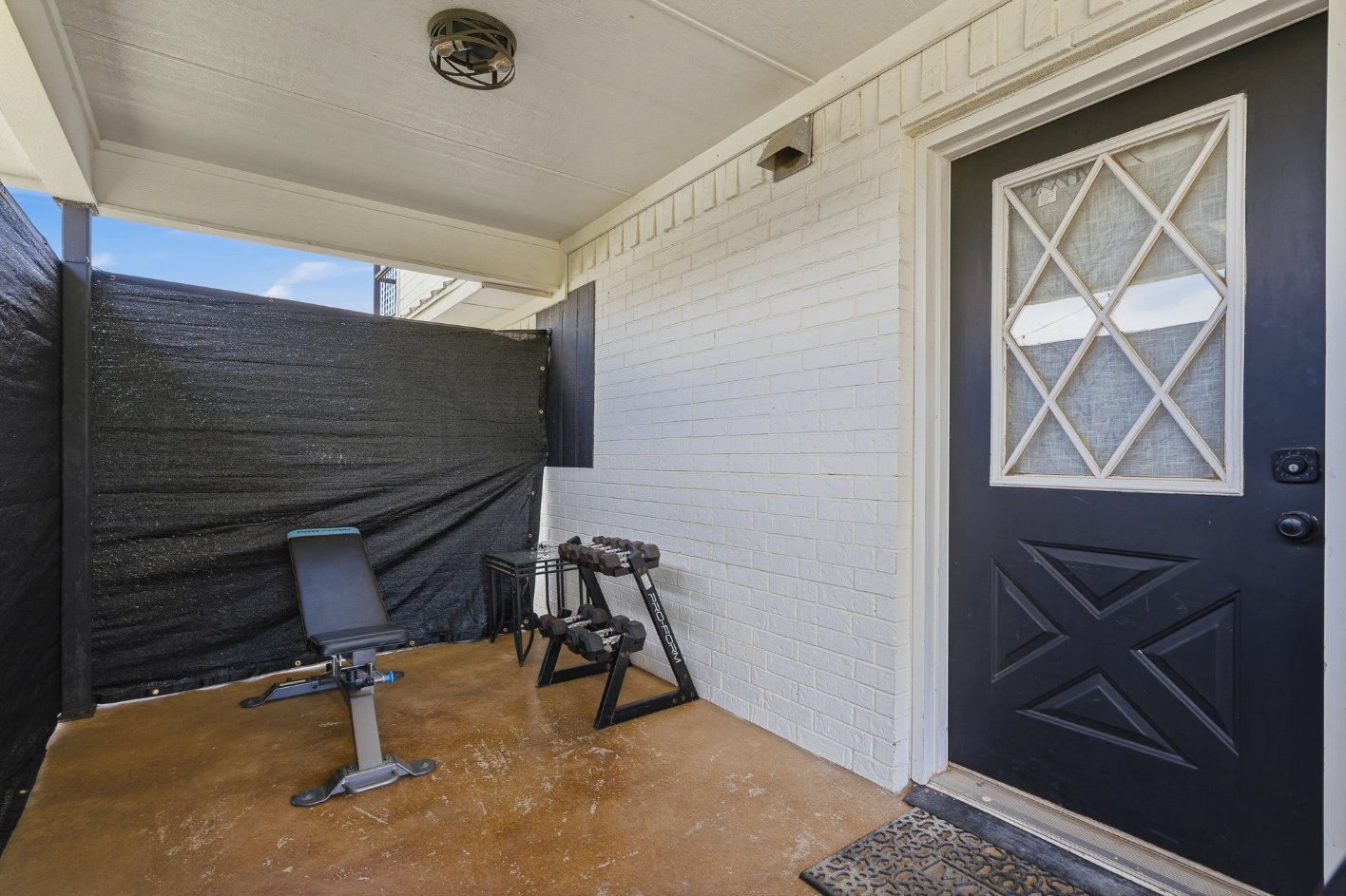 Covered private porch with entryway and convenient workout setup