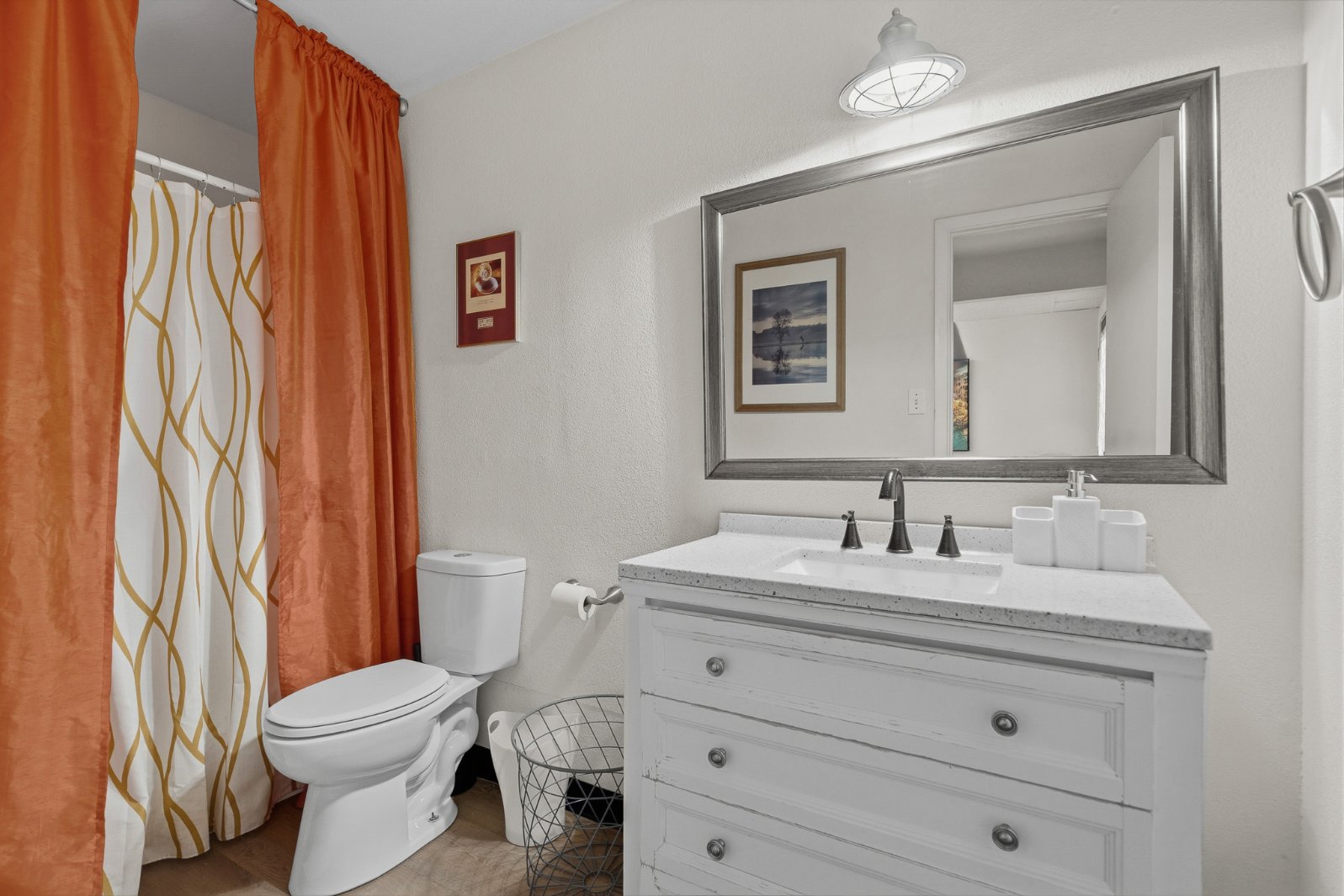 Bright modern bathroom with stylish vanity and full shower-tub