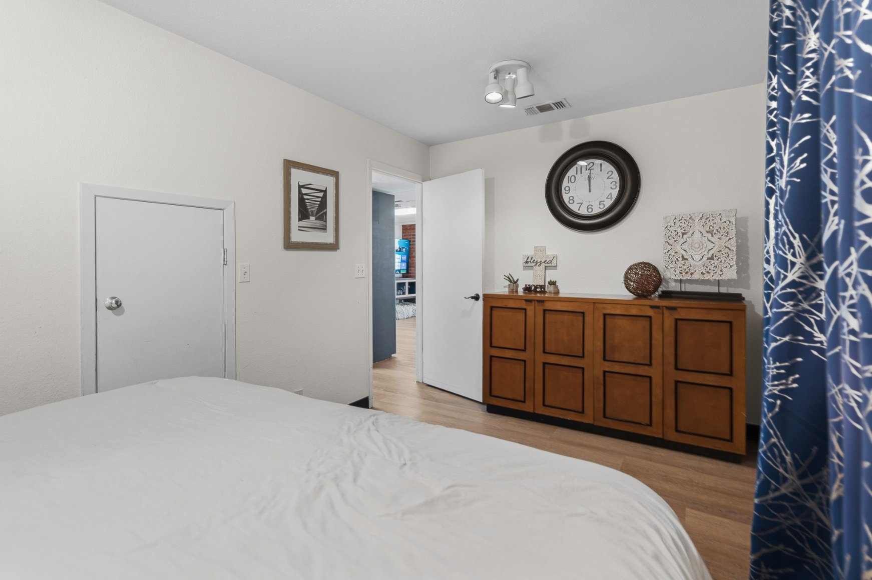 Bright minimalist bedroom with stylish dresser and cozy, calming decor
