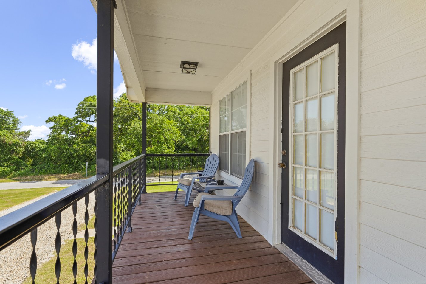 Covered front porch with seating and peaceful green views