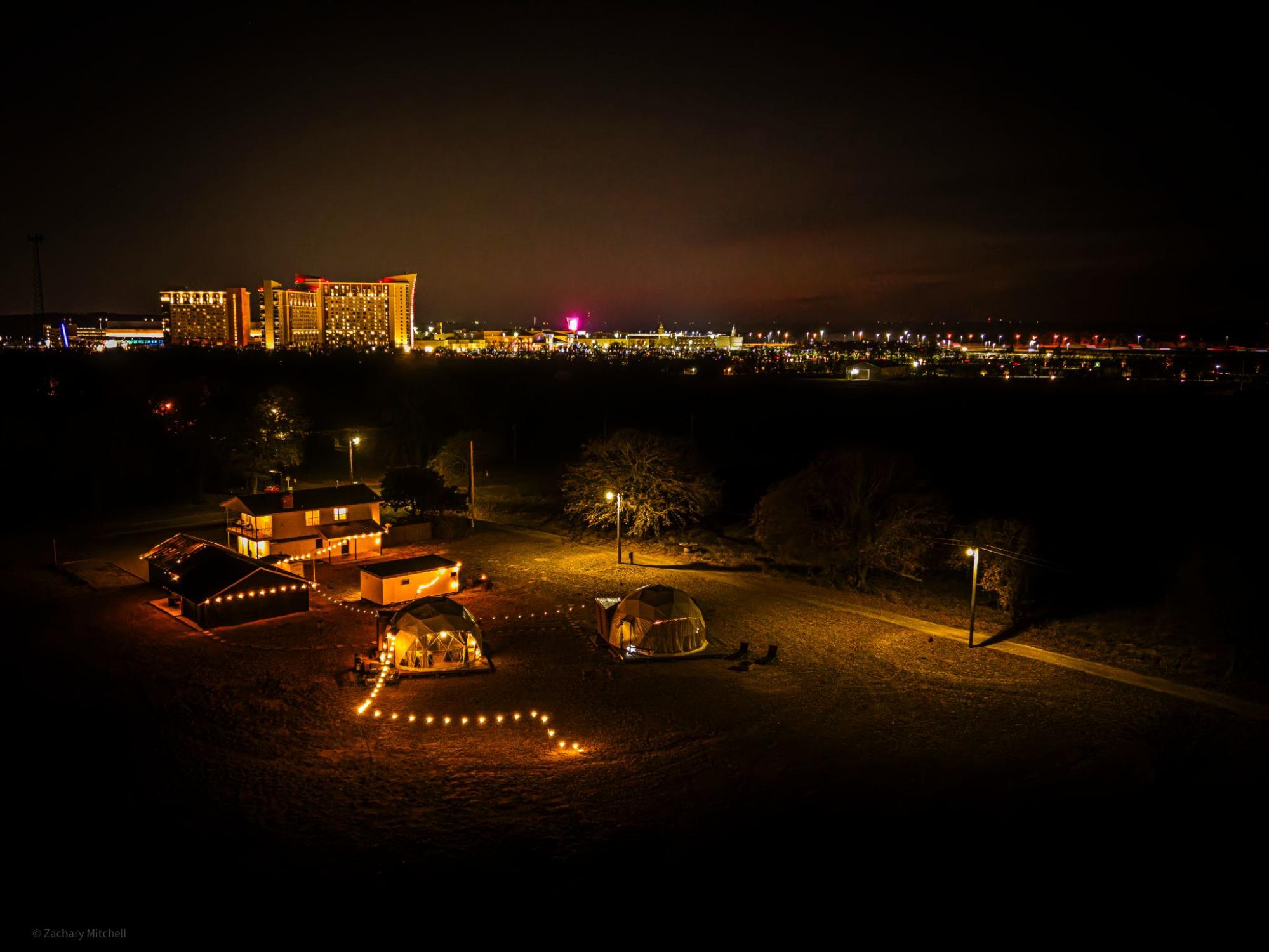 Cozy glamping retreat with glowing lights and stunning city views