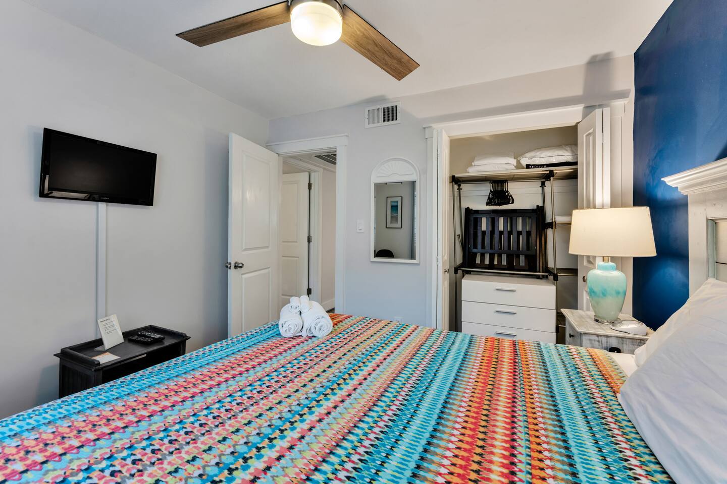 Cozy sleeping space with natural light and ceiling fan
