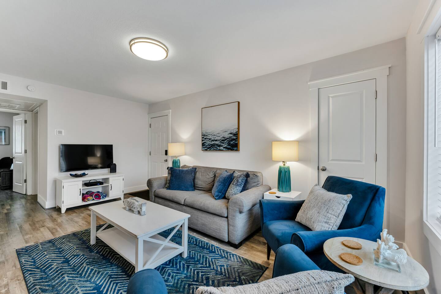 Bright coastal living room with comfortable seating and beach-inspired décor