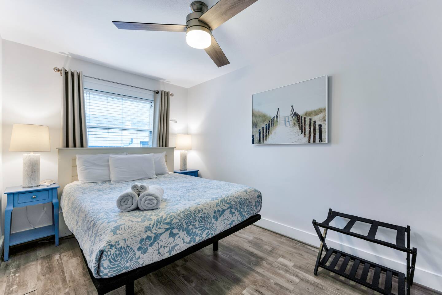 Inviting second bedroom with ceiling fan and natural light