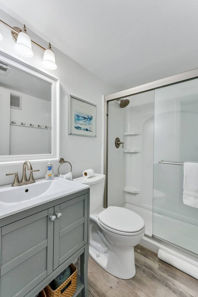 Bright full bathroom with modern finishes and glass-enclosed shower
