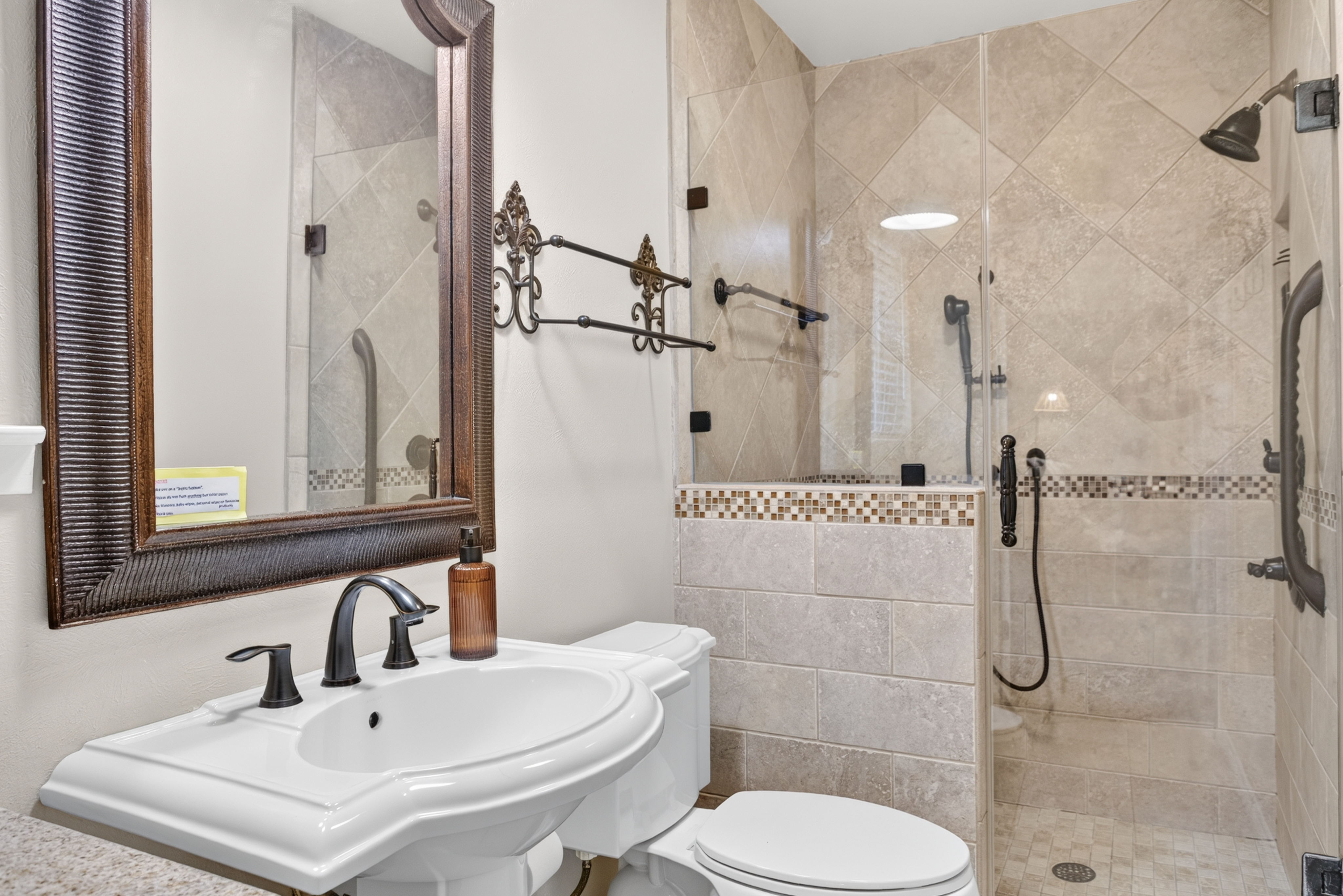 Spa-like tiled bathroom with glass walk-in shower and elegant finishes