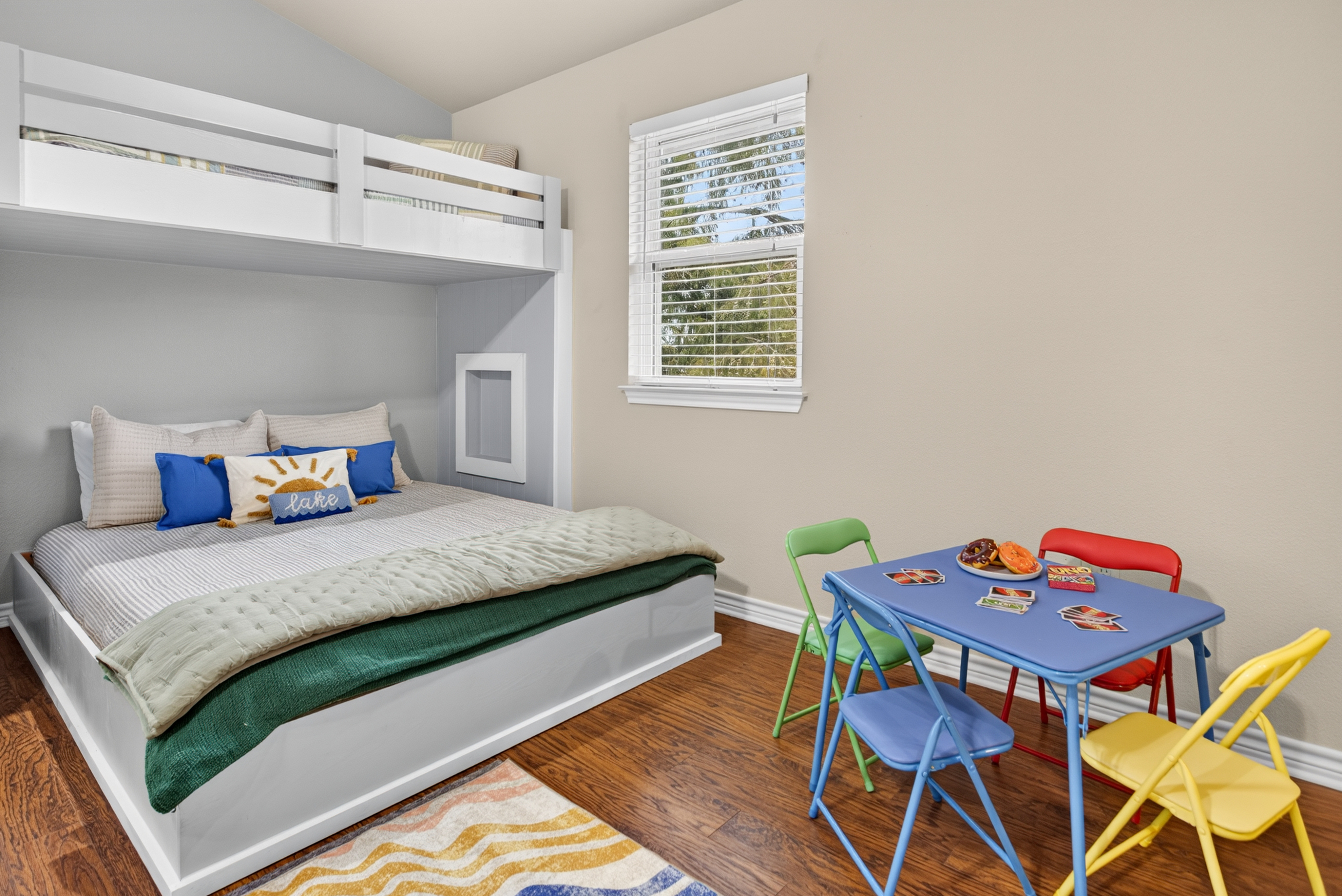 Bright kids’ room with bunk bed and colorful play table