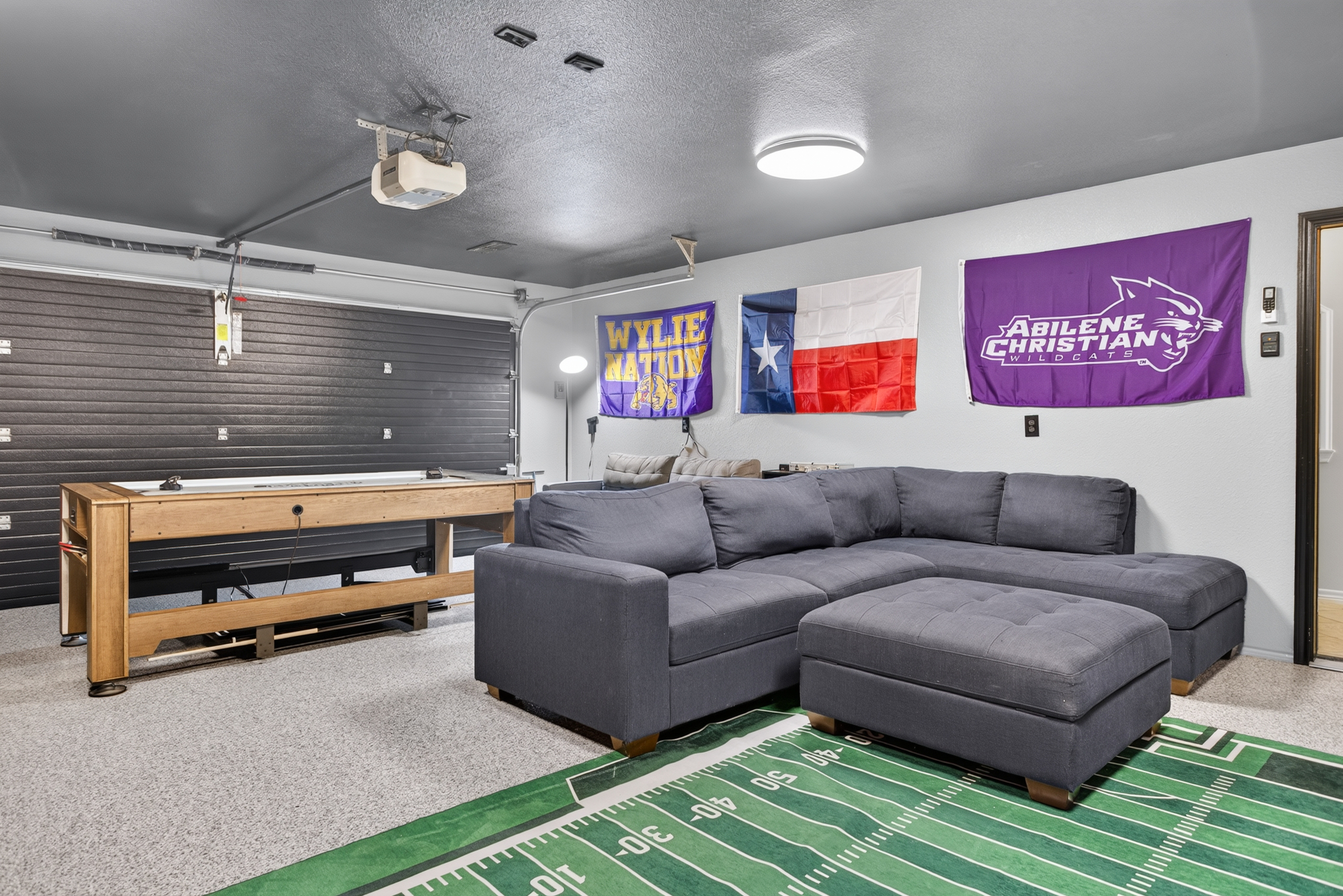 Spacious game room with sectional seating and shuffleboard fun