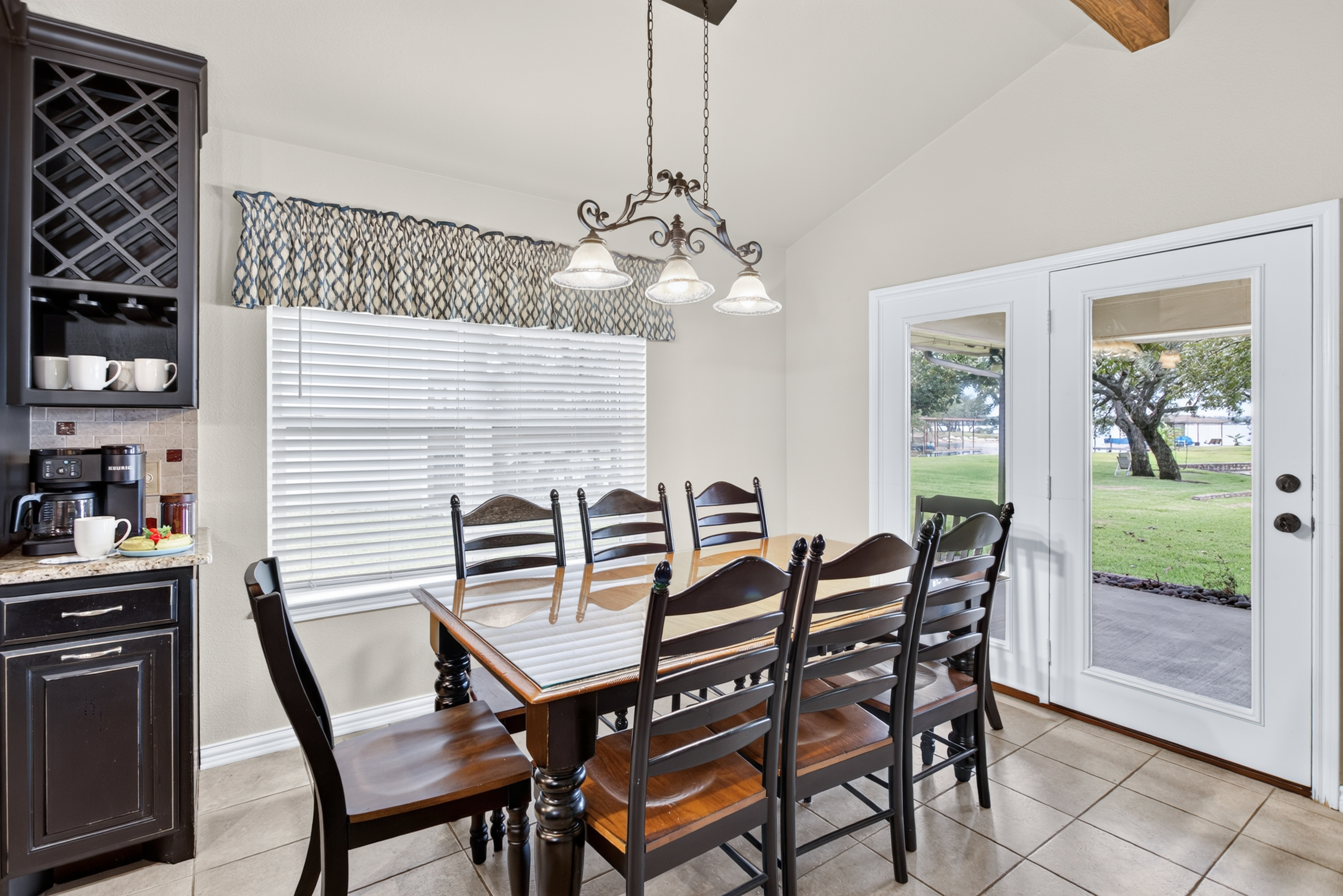 Bright dining area for 8 with patio doors and backyard views