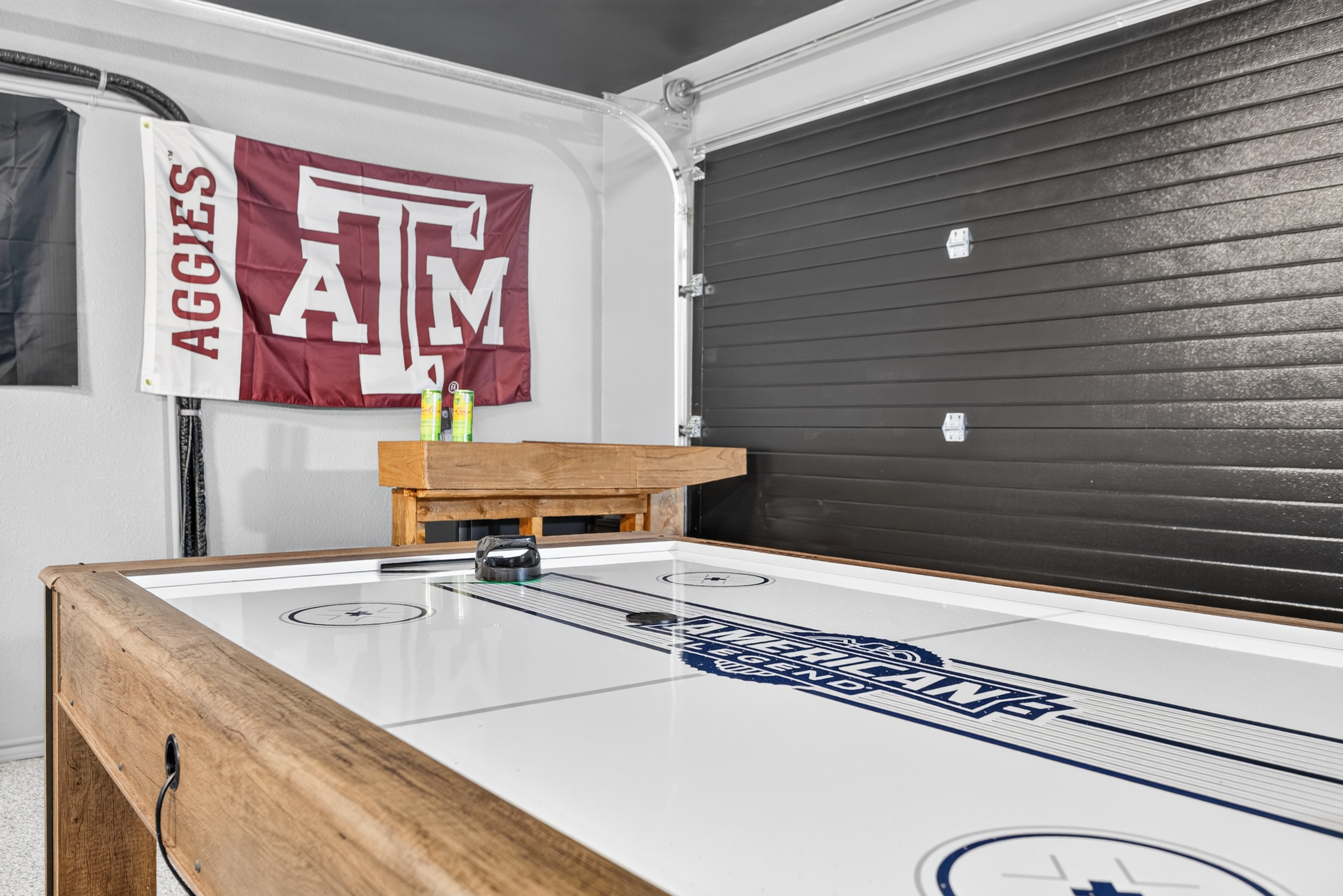 Garage game room with air hockey table and fun Texas A&M flair
