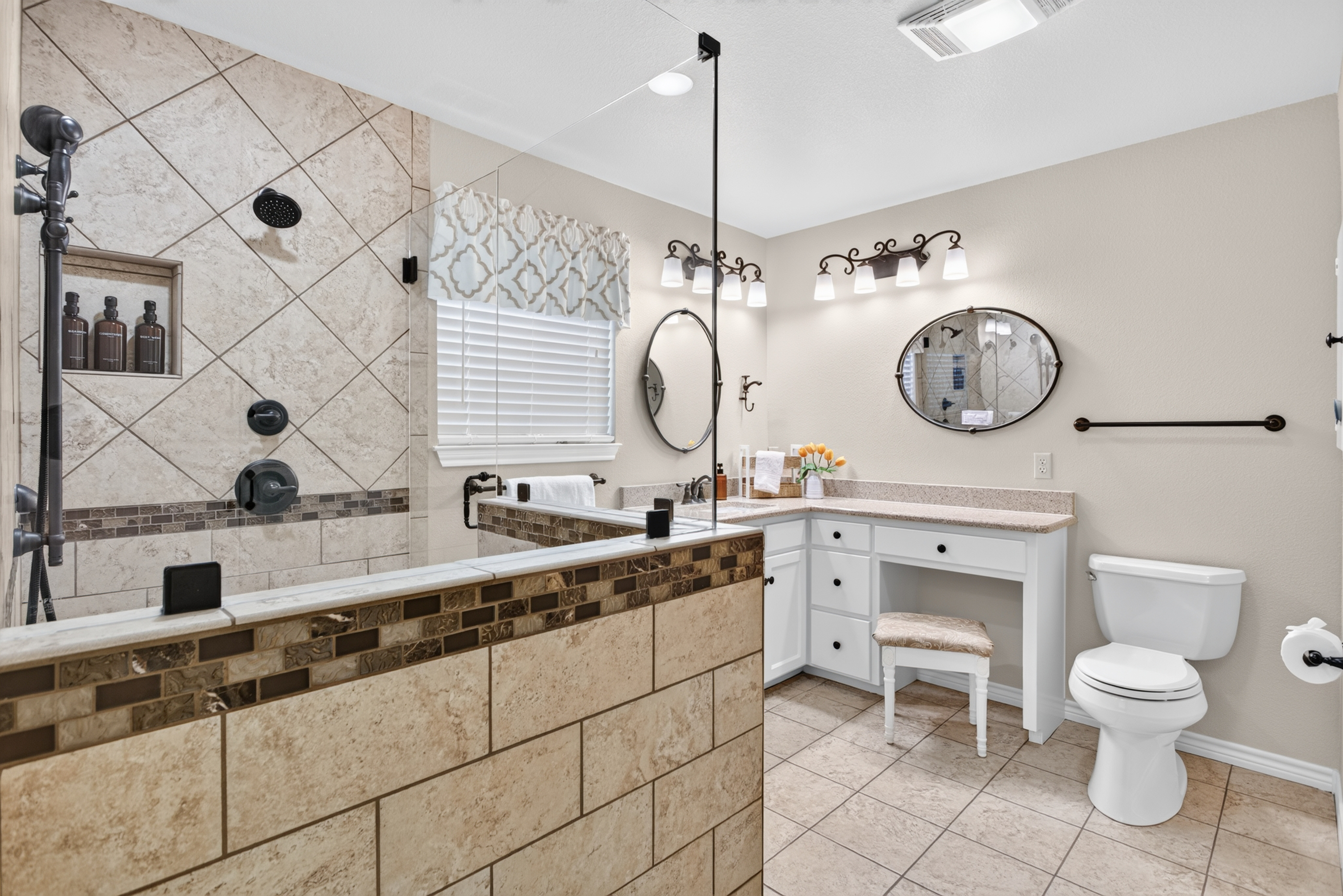 Spa-like bathroom with large walk-in shower and vanity seating