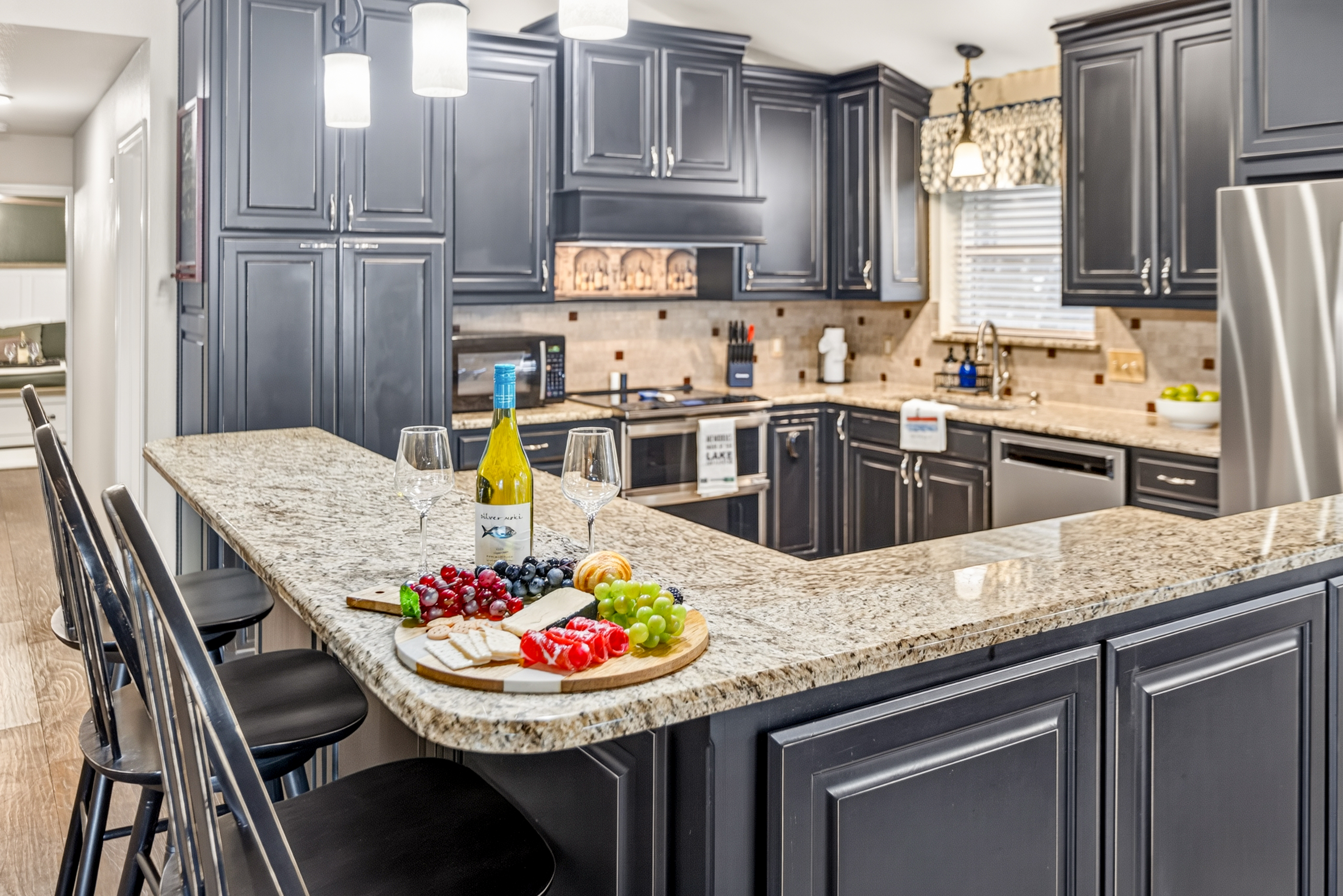 Spacious granite kitchen island with bar seating and elegant modern finishes