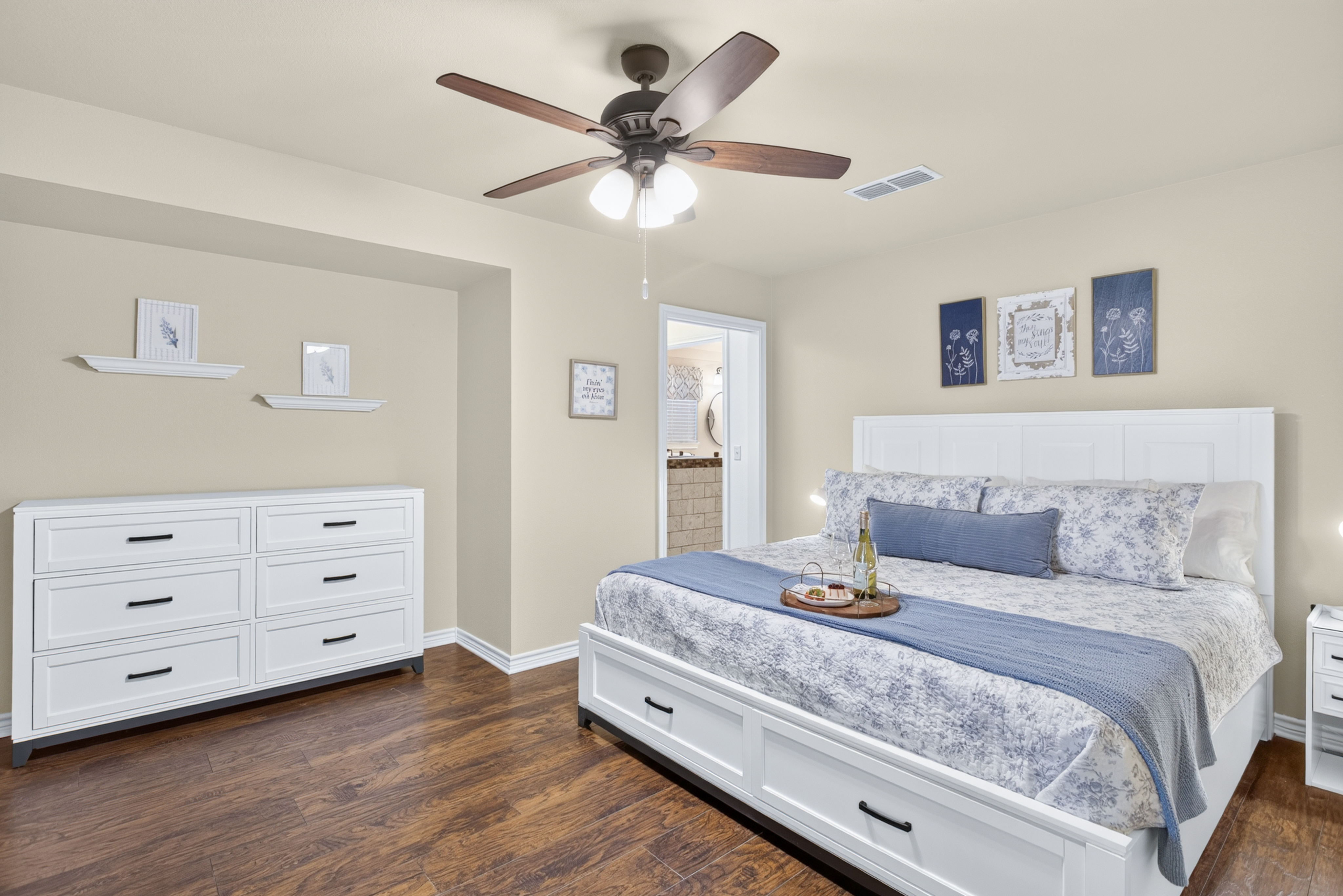 Spacious bedroom with king bed, storage drawers, and serene blue accents