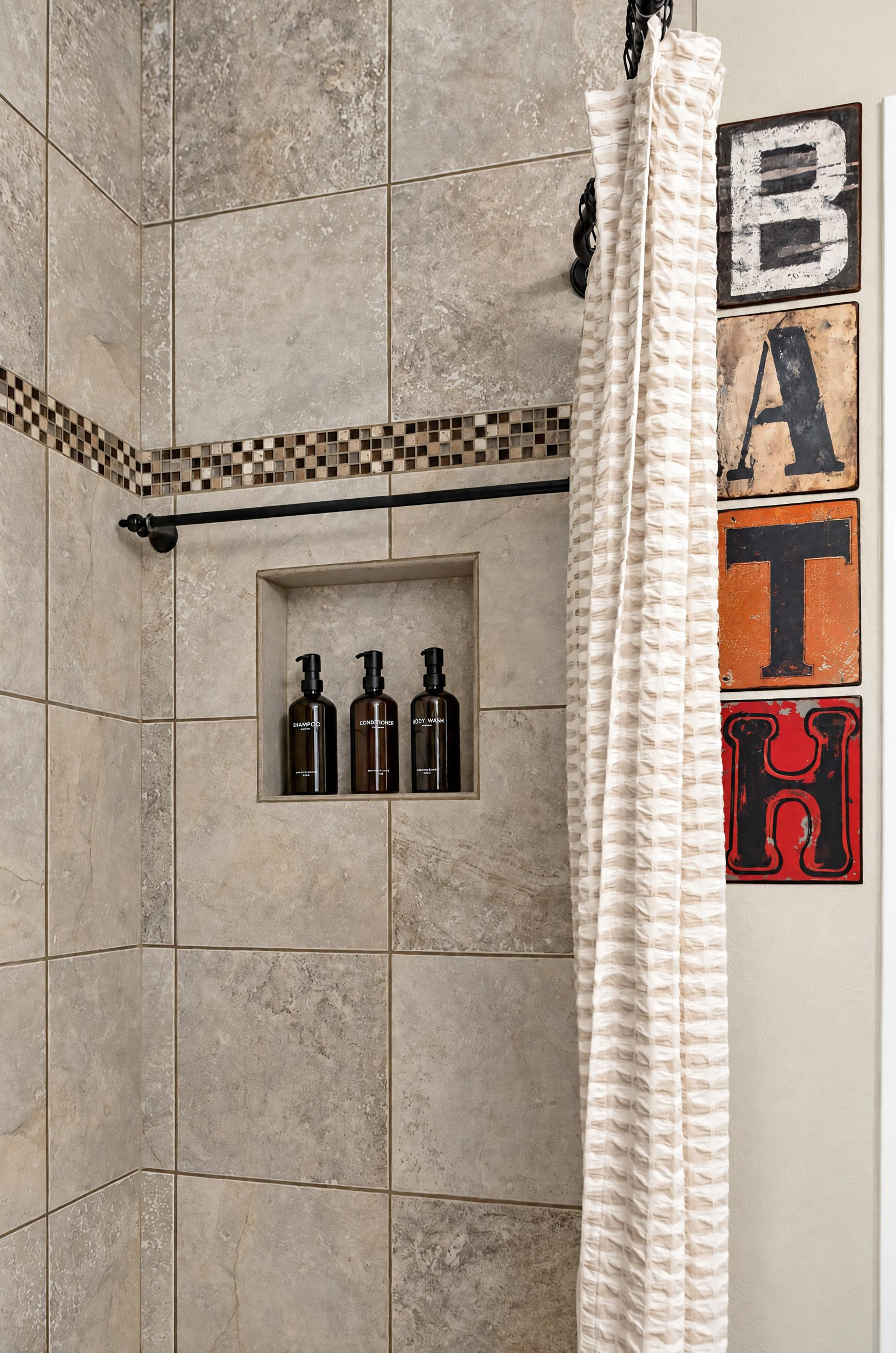 Stylish tiled walk-in shower with built-in niche and bold bath decor