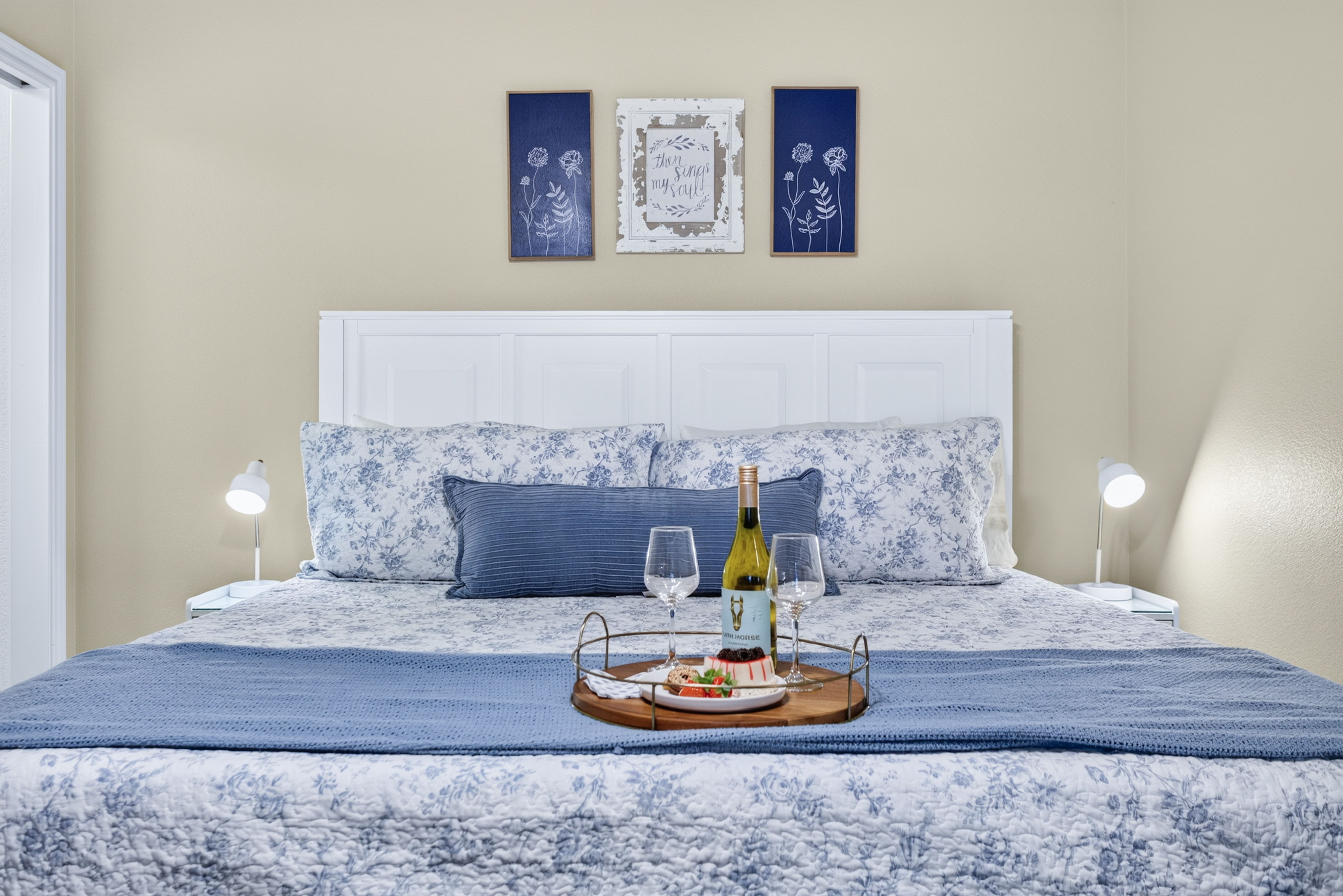Cozy blue-and-white bedroom with wine welcome and elegant touches