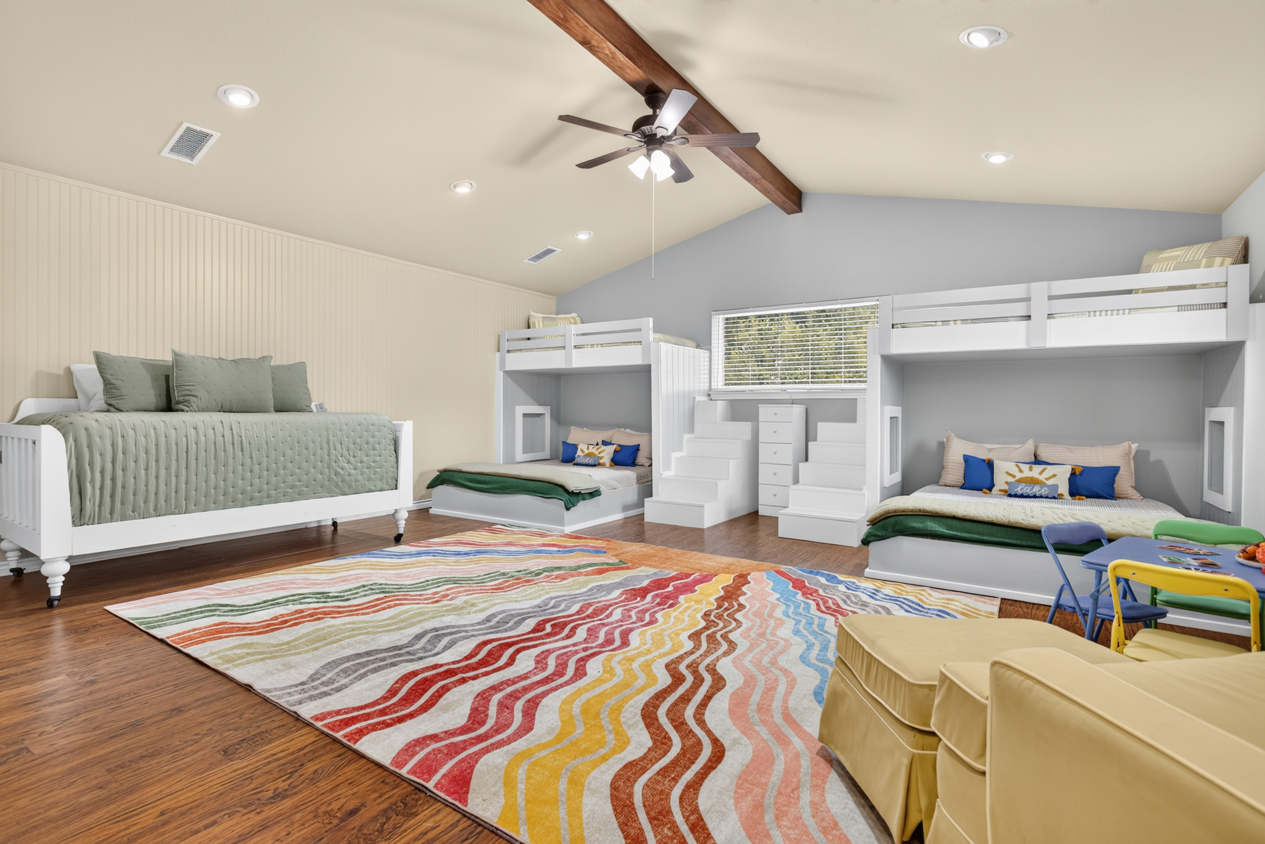 Spacious family bunk room with colorful decor and extra sleeping space