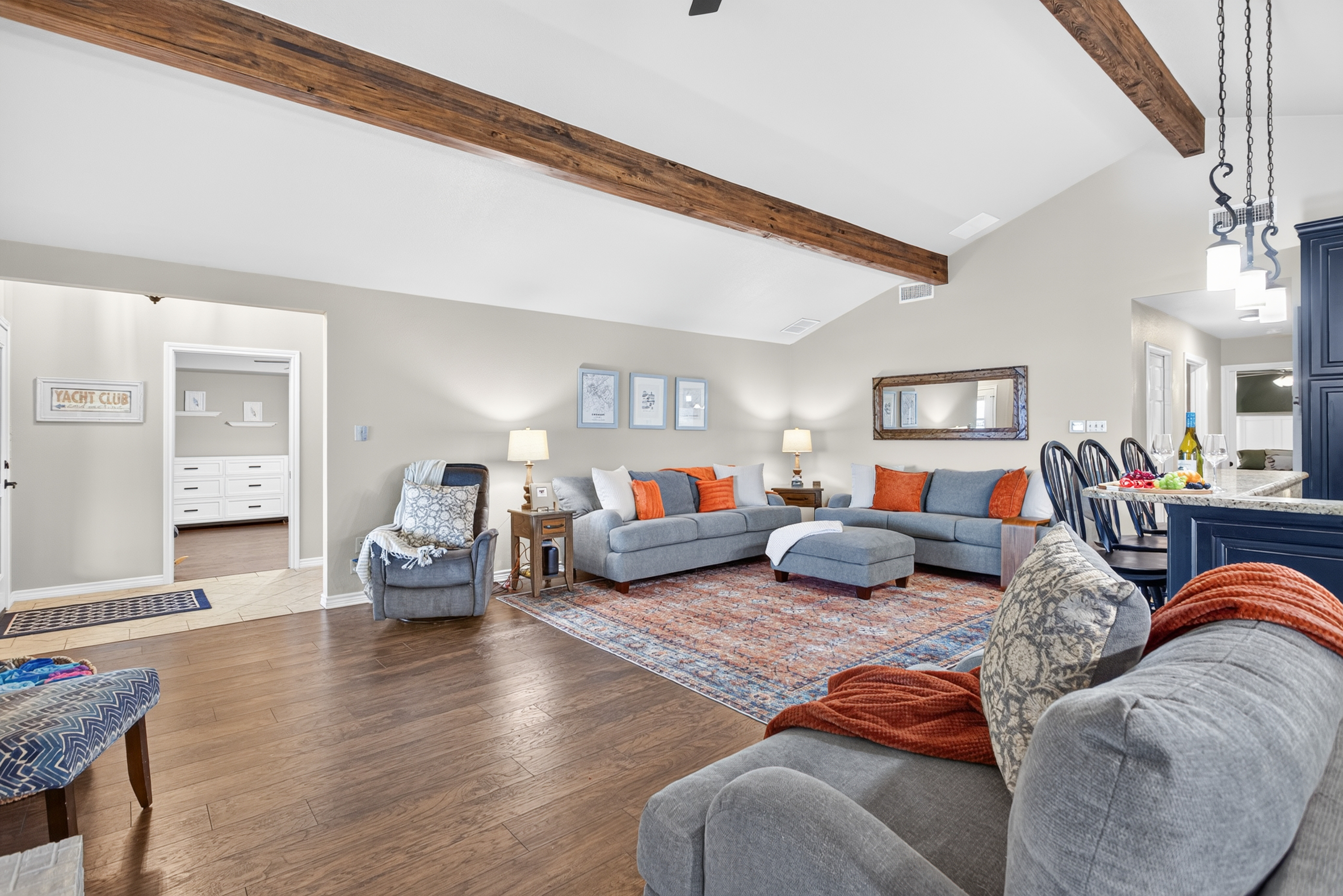 Spacious great room with vaulted ceilings, exposed beams, and cozy seating