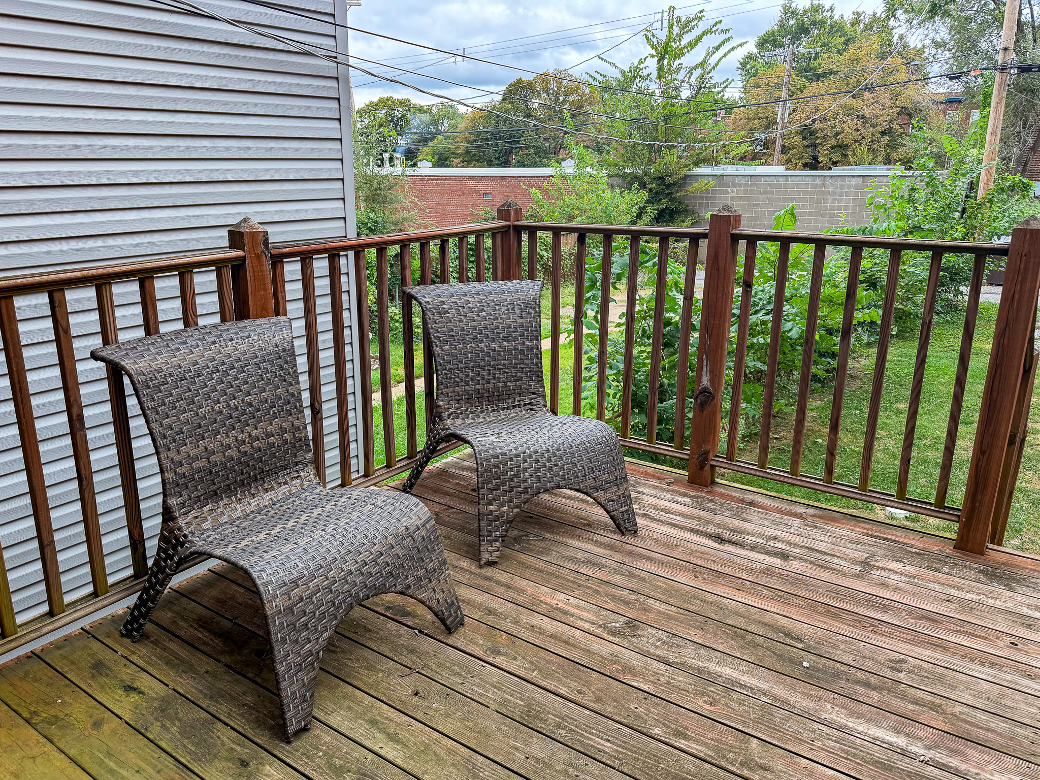Private outdoor deck with lounge seating and backyard views