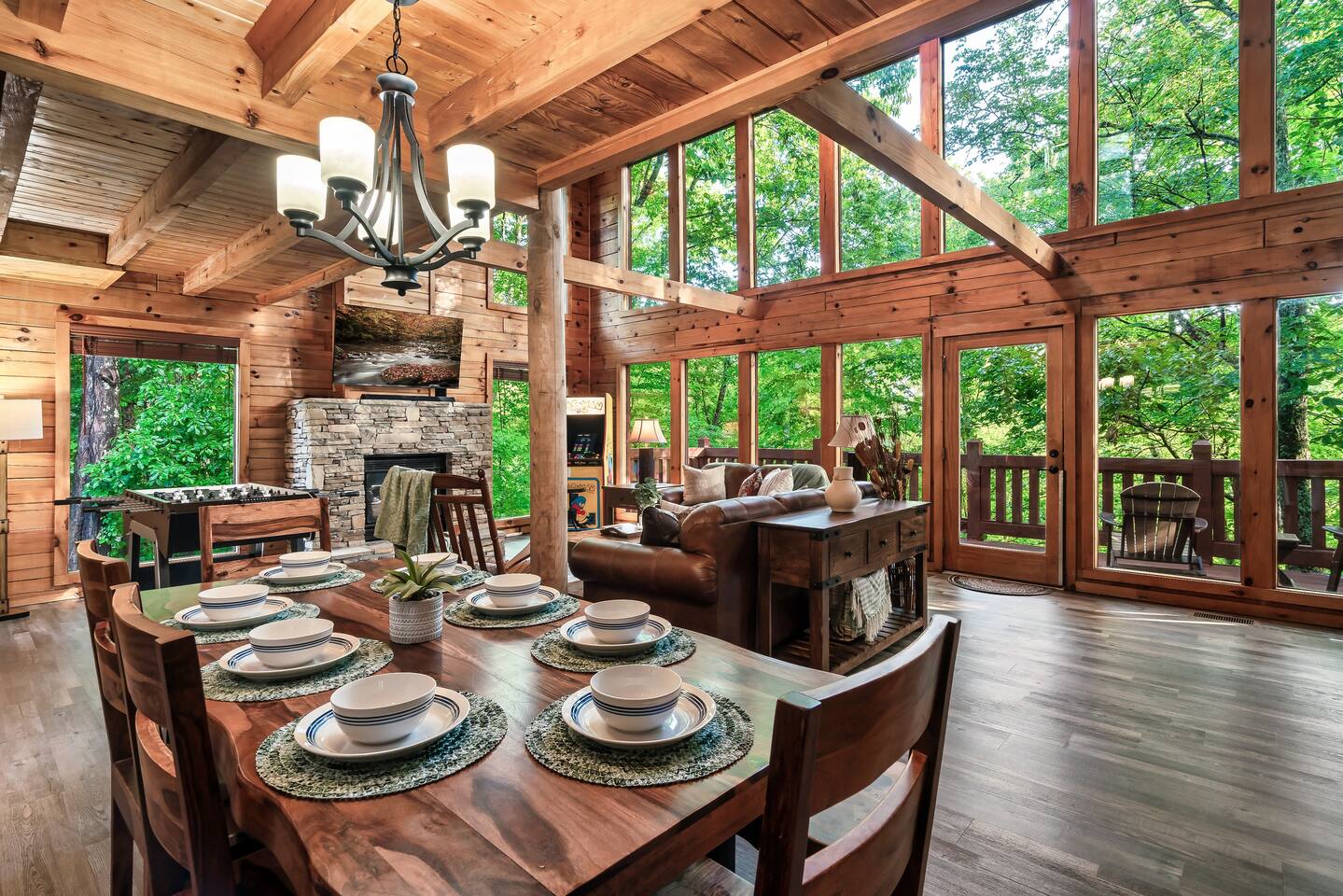 Rockstar Retreat great room with floor-to-ceiling windows, stone fireplace and arcade