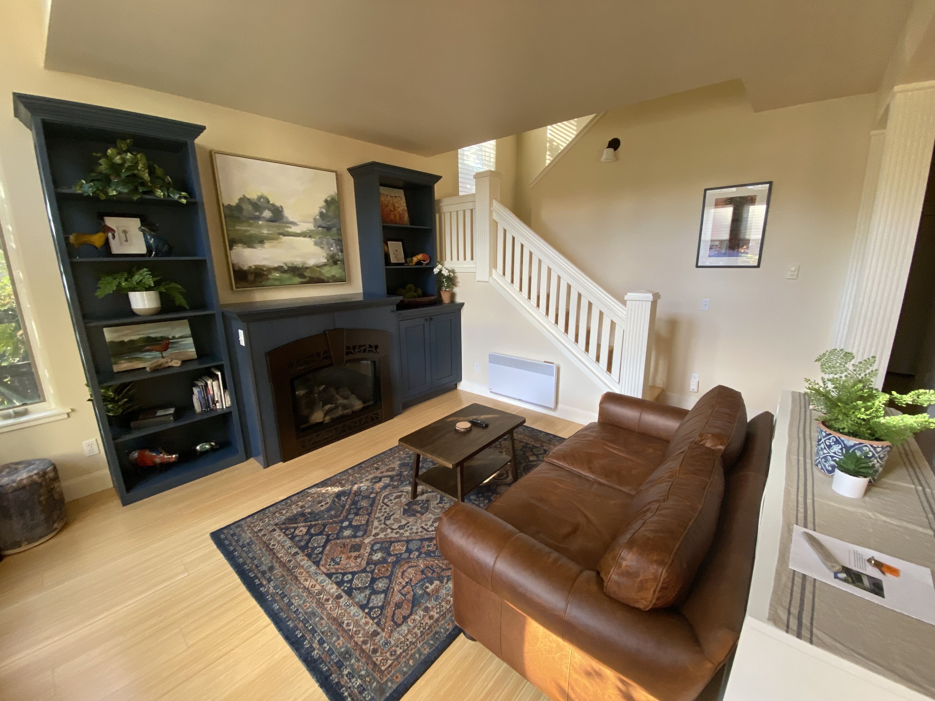 Cozy living room with gas fire place and comfy leather couch with big screen TV