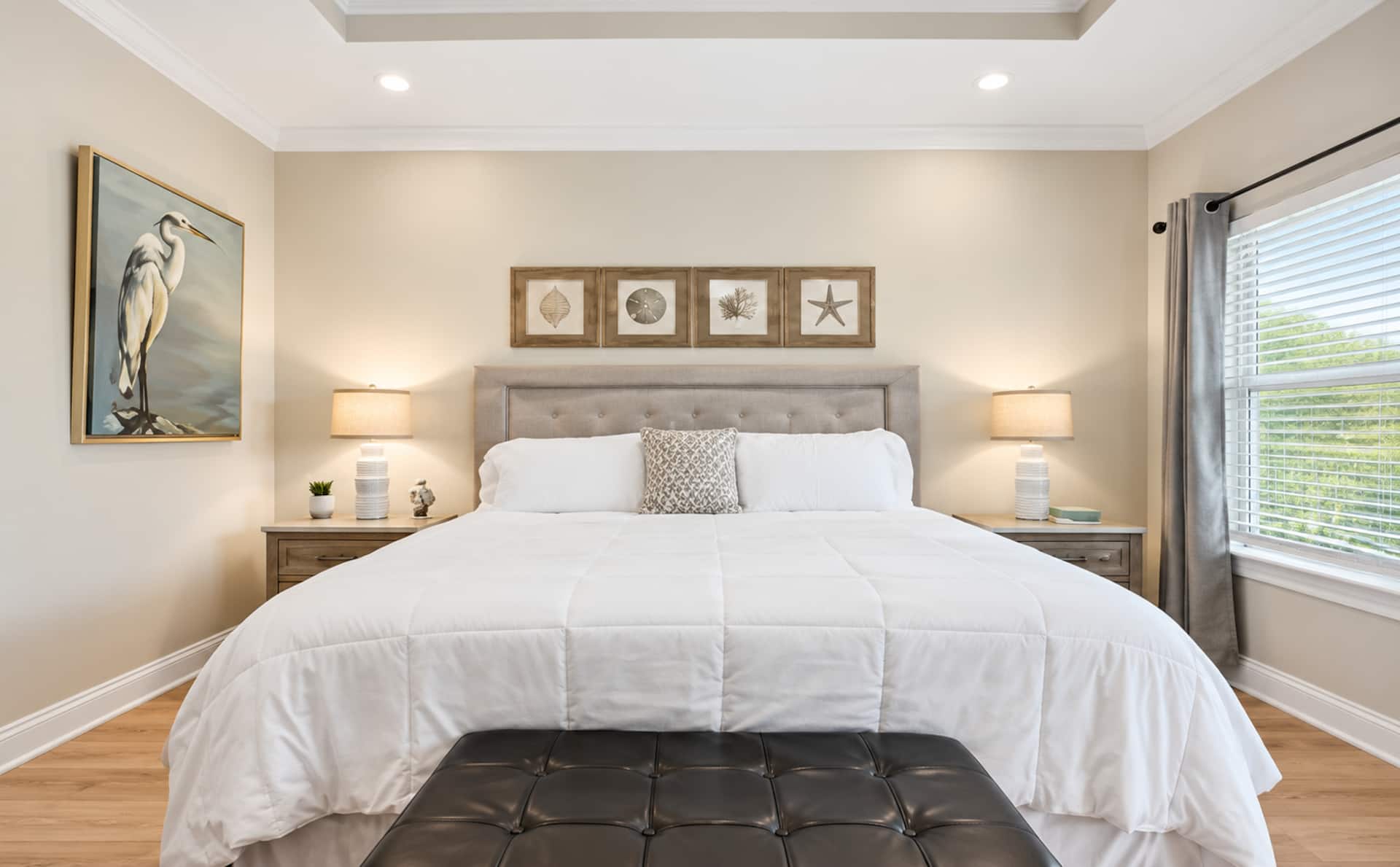 Bright coastal-inspired king bedroom with elegant finishes
