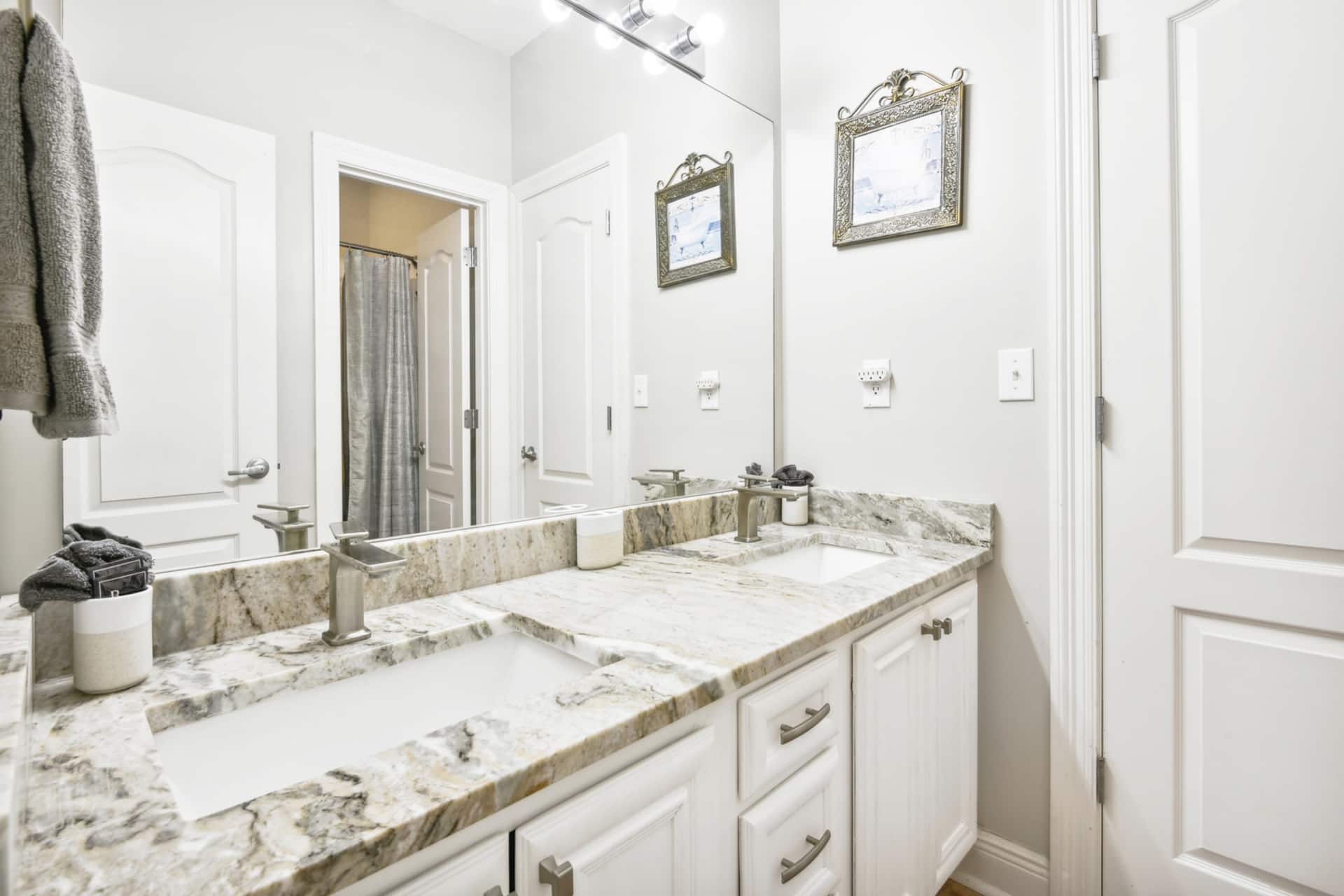 Bright double vanity bathroom with elegant marble-style countertops