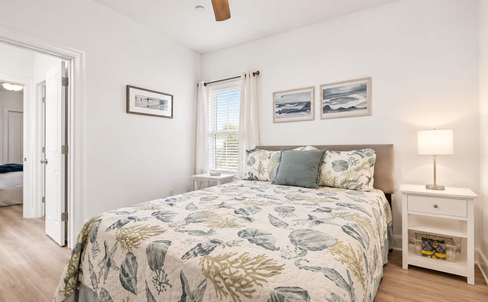 Bright coastal bedroom with queen bed, natural light, and soothing decor
